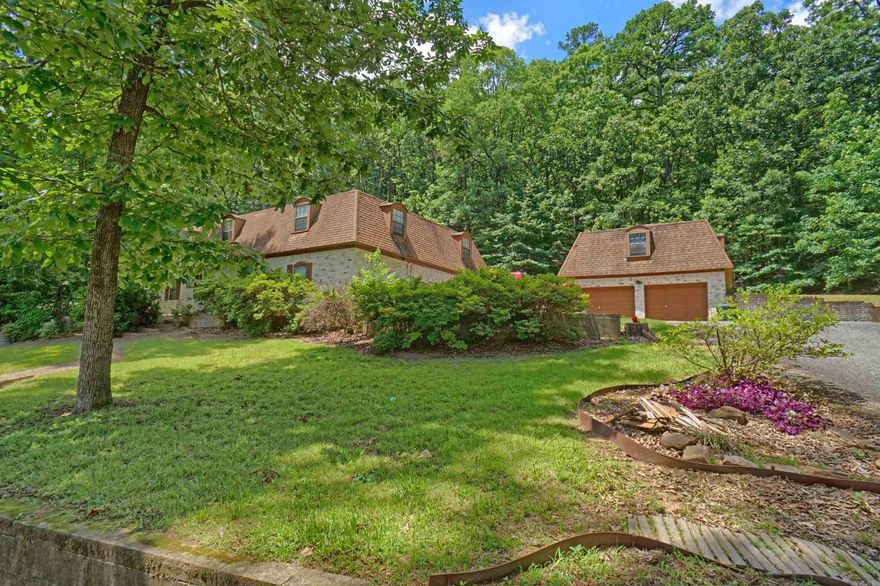 This spacious 3,700 SF brick home on the West side of Russellville offers incredible flexibility and room to grow. Inside, you’ll find five generous bedrooms, four full baths, and a half bath. The upstairs layout includes four bedrooms, three full bathrooms, and a convenient laundry room—all tucked away for privacy. Downstairs features the fifth bedroom with its own full bath, plus a guest half bath, making it ideal for a separate living arrangement. The main level also includes a dining space, multiple living areas, including a traditional living room and a second versatile space perfect for a den, media room, or family room, along with a bonus room that could serve as an office or hobby space. Two central heat and air units ensure comfort throughout. A two-car detached garage offers even more possibilities with upstairs living quarters or storage space. While the home is in need of some attention, it’s a rare opportunity to own a large, adaptable home in a desirable west Russellville location!