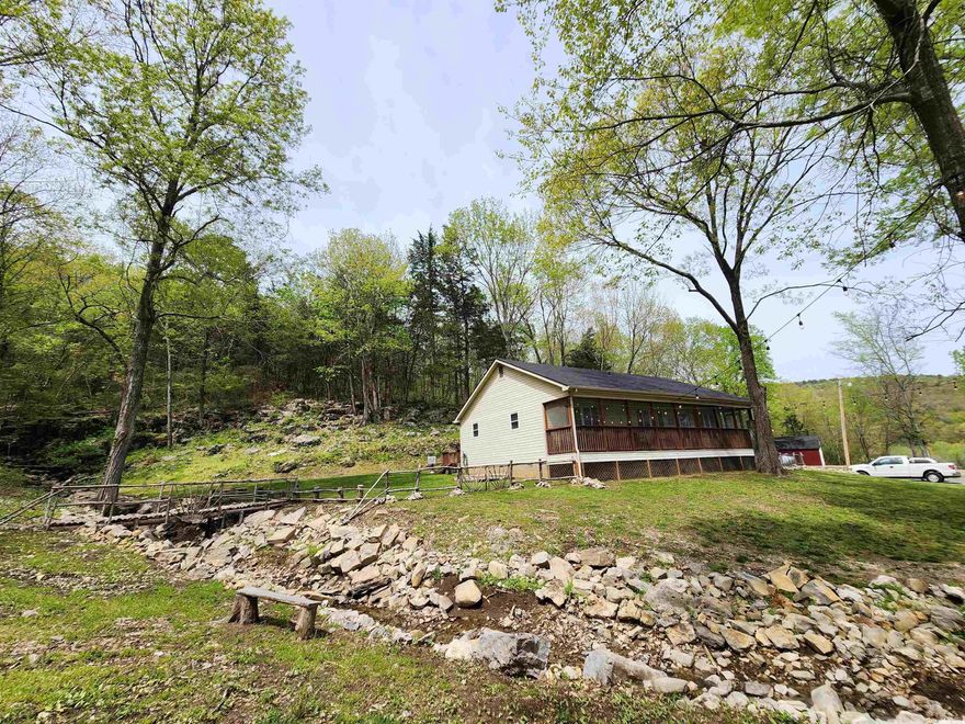 Welcome to market 50 Base Lane, this charming home sits on 9 acres m/l. This home offers 3 bedroom, 2 baths, home was remodeled with nee flooring, cabinets, vanities, fixtures, farm house sink, instant hot water heater, attic fan, new windows, 2 space heaters, hvac,  a new roof on home and shop, nice deck off back of house with a screened in porch, well maintained home & property, home also offers a circle driveway, 2 of the acres has its own power pole & would be a great place to build shop or cabin. Waterfall runs approx 6 months of the year! Wonderful to listen to while on back porch or while enjoying the day outside! Other great places to build cabins behind the homes. call for your showing TODAY!