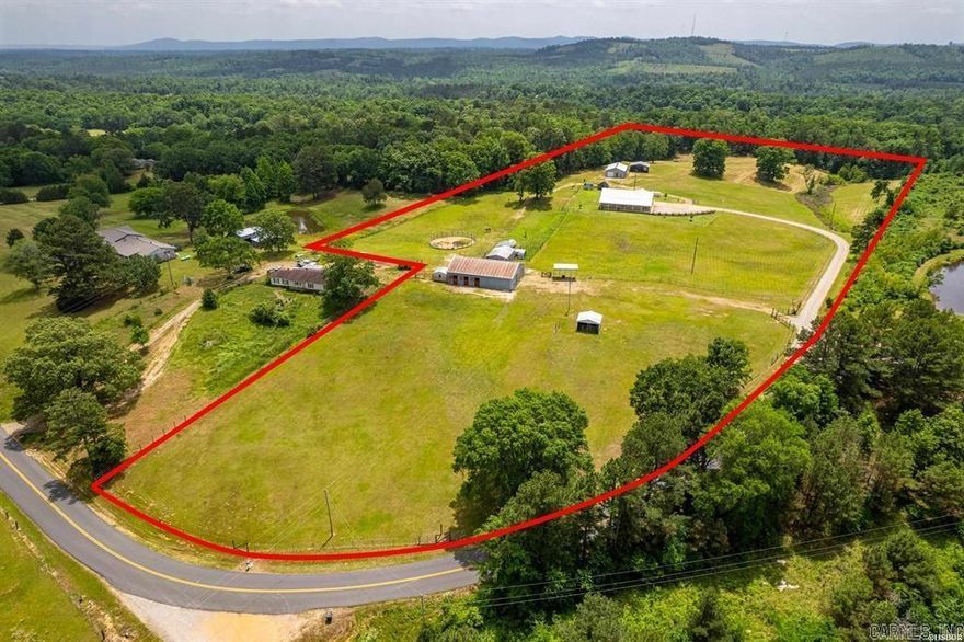 **Charming Ranch Estate Retreat! Your Dream Homestead Awaits!**  Welcome to your private oasis! Nestled in the heart of nature, this stunning ranch estate offers a harmonious blend of rural charm and modern convenience, perfect for horse lovers and hobby farmers alike.  The home sits on top of ridge with views in all directions. Step inside and be greeted by an expansive open-concept layout where a vaulted ceiling soars overhead, creating a bright airy feeling throughout. Beautiful cork floors underfoot not only add a warm aesthetic, but also provide both durability and style. Enjoy preparing meals in the kitchen while you entertain family and friends. Custom soft close cabinets, large island and upscale appliances make it easy to enjoy. Just off of the kitchen you will find a very large screened in porch where you will enjoy soft breezes and beautiful views. The spacious master suite features a luxurious ensuit with his/hers walk in closets. The large master bath features his/her vanities, water closet and a large shower. The Second and Third bedroom are thoughtfully placed on the other side of the home from privacy. The third bedroom is currently being utilized as an home office