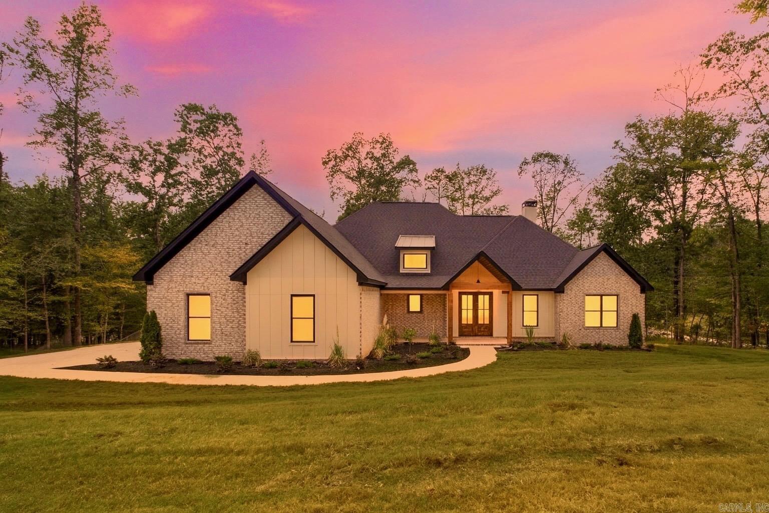 Stunning new construction in gated Big Rock Estates on 1.28 acres! This 4BR/3.5BA home features a cathedral ceiling, abundant natural light, and custom wood details. The open living area with wood-burning fireplace flows into a chefās kitchen with quartz countertops, spacious island, gas range, and walk-in Butlerās pantry. The primary suite offers a spa-like bath with soaking tub, wraparound shower, double vanities, and oversized closet with laundry access. Upstairs includes a bonus room, bedroom, and full bath, while outside a massive covered porch with wood ceiling detail and fireplace creates the perfect entertaining space. Complete with a 3-car garage and dedicated office. Many upgrades including sprinkler system, foam insulation, and outdoor fireplace with chimney. Bryant Schools!