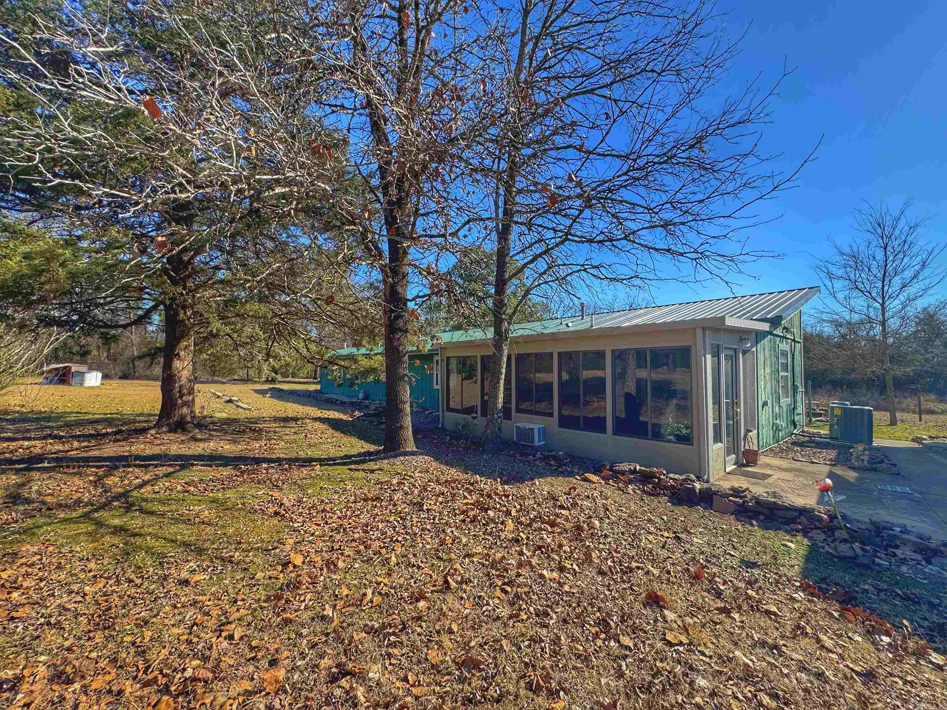 Spacious 4-Bed, 3-Bath Home on 5.27 Acres with TWO new HVAC units, Abundant Storage AND an Assumable Loan at 2.875%!! Enjoy the perfect blend of comfort and functionality with this 4-bedroom, 3-bathroom home featuring a split floor plan for privacy and flexibility. Set on 5.27 flat, usable acres, this property is ideal for those needing ample space both inside and out. The home boasts a 9' x 22' sunroom, perfect for relaxing or entertaining. Outside, you'll find a two-car detached garage, a large covered three-stall storage shed, an 11'9'' x 12'3'' greenhouse, and even a wood chipper to maintain the expansive property. With room to spread out, work, and store all your tools and toys, this property is a must-see!