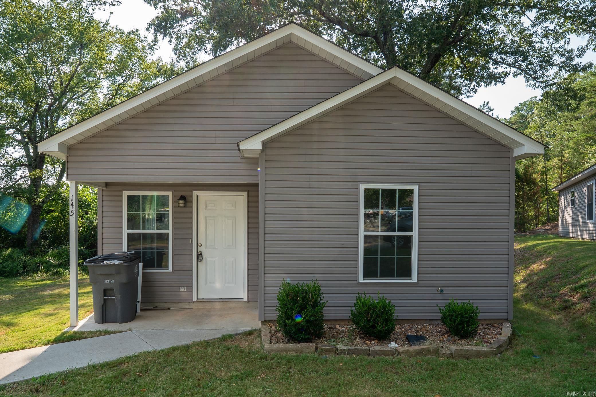NEWER CONSTRUCTION home, showcasing a perfect blend of style, efficiency, and affordability in Hot Springs, Arkansas. Located in Lakeside School District, this modern patio home features eye-catching designs and contemporary finishes. SELLER OFFERING TO PAY half of BUYER'S CLOSING COST!! With its sleek modern colors, stylish flooring, and gorgeous granite countertops, this home stands out on 2 LOTS, creating MORE YARD SPACE and charming curb appeal. Ideal for those who appreciate both aesthetic and practicality, this home is designed for comfortable living. Positioned in an excellent location, you'll be just 5 minutes from Oaklawn Gaming and Racing, making it a fantastic choice for entertainment enthusiasts. Plus, you'll be only 10 minutes away from the historic downtown area, renowned for its iconic bathhouses and vibrant atmosphere. Donāt miss the opportunity to make this inviting patio home yours in the heart of this famous cityāperfect for both relaxation and enjoying all that Hot Springs has to offer!
