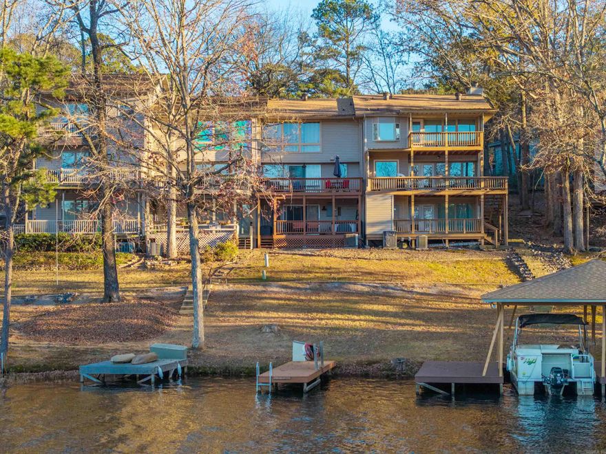 Enjoy serene lake views from this beautifully maintained three-level condo on Lake DeSoto in the heart of Hot Springs Village. Designed for both relaxation and entertaining, this waterfront retreat features two spacious decks overlooking the lake, perfect for morning coffee or sunset gatherings and comes with its own private swim dock for lounging, swimming or launching.  The thoughtfully designed multi-level layout offers privacy and comfort, while large windows bring in natural light and showcase the stunning water views. Selling fully furnished with an acceptable offer, this condo is truly turn-key, making it ideal as a full-time residence, weekend getaway, or investment property.  Located in one of Hot Springs Village’s most desirable lakefront settings, residents enjoy access to world-class amenities including golf courses, trails, lakes, and a vibrant community lifestyle.