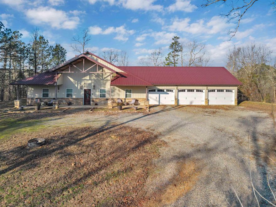 Barndominium-style home on 4.59 mostly wooded acres near Harris Brake Lake, offering space, privacy, and a layout great for entertaining. This home features 4 bedrooms, 3 full bathrooms, oversized walk-in closets, whirlpool tubs, huge laundry room with built-in cabinets and a 3-car garage. Ring cameras and a monitored security system with cameras already installed provide added peace of mind.  A bonus area off the garage includes a main-level room plus an upper-level space currently used as a guest room—ideal for guests, a home office, or flex space. Additional features include spray-foam insulation, a metal roof, fiber internet availability, and extensive floored attic storage.  Enjoy sunrise views from the front porch and sunsets from the back porch. Outdoor highlights include an in-ground fire pit, established walking trail, fenced dog run, and ample space on both the north and south sides of the home for boat storage, a future shop, or a garden.  Conveniently located for outdoor recreation: approximately 20 minutes to Petit Jean State Park, 30 minutes to Pinnacle Mountain State Park, 15 minutes to Lake Maumelle, and 10 minutes to Lake Sylvia.
