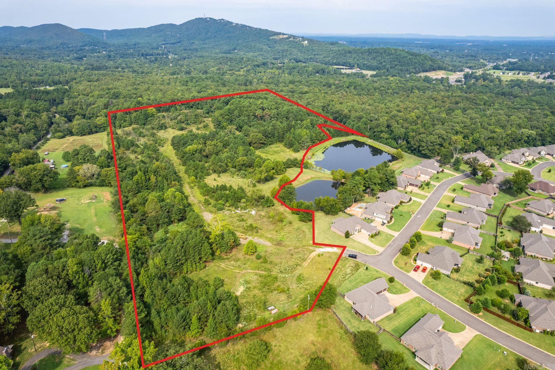 28 Acres +/- Adjacent to Glencarin Subdivision. This beautiful 28-acre parcel offers a rare opportunity to develop or invest in land adjoining the desirable Glencarin Subdivision. With direct access via the publicly dedicated county road through Glencarin or Lee Warren Lane, the property is ideally positioned for future growth. Underground utilitiesāincluding water, sewer, electricity, and natural gasāare available in the adjoining subdivision and are expected to be accessible for development. Buyer to verify availability and associated costs. Two scenic ponds along the eastern boundary enhance the natural beauty of the property and contribute to the sense of community in the adjoining Glencarin Phase I subdivision. These ponds are designated as common areas for Phase I residents and are not included in this sale and not owned by the seller. Enjoy exceptional privacy and stunning views, all just 10 minutes from major shopping centers and medical facilities in the city. This property combines tranquility with convenienceāperfect for a residential development or a private estate.