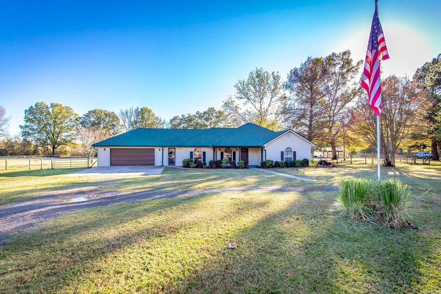 Welcome to your home sweet home — the perfect blend of privacy, comfort, and luxury. As you pull into the circle drive, you’re greeted by beautiful, ornate landscaping complete with a charming fountain, along with the low-maintenance appeal of vinyl siding and a durable metal roof.  Step inside from the covered front porch and you’ll find a semi-open floor plan designed for gathering. The spacious living area easily accommodates large furniture arrangements and is ideal for movie nights with the projector and screen that convey with the home.  The kitchen is truly breathtaking, featuring brand-new granite countertops, freshly painted cabinets, an updated island, and new hardware throughout. Just off the main living space, a cozy sunroom overlooks the expansive backyard — fully fenced and cross-fenced — offering views of the above-ground pool, a generous patio area, a large storm shelter, and two shops. Both shops have electricity; the front shop is insulated and includes a 220-volt outlet, making it perfect for projects or hobbies.  Back inside, you’ll appreciate the oversized bedrooms and impressive closet space. The former detached garage has been seamlessly connected to the home