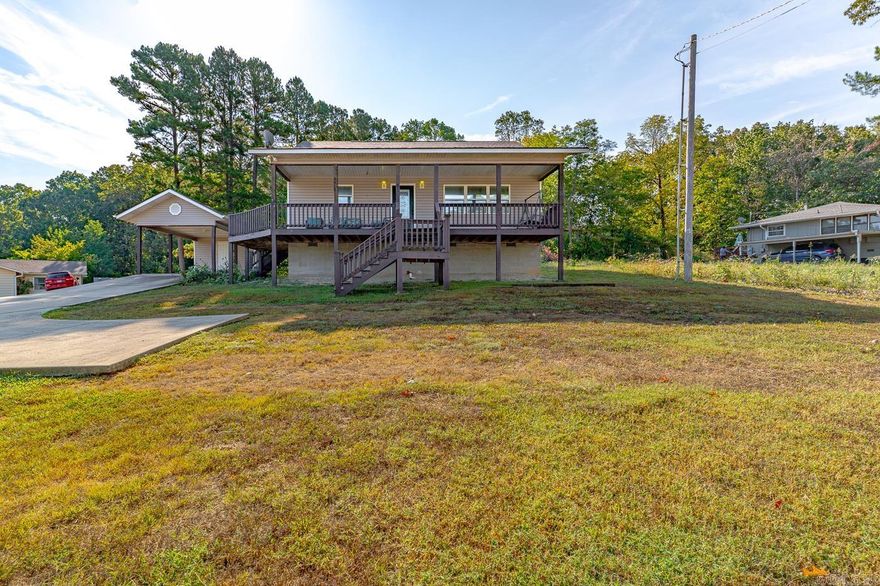 Welcome to the market another Compass Rose Realty Exclusive property, located at 14 Yosemite Dr. in Cherokee Village Arkansas. Upon entering the home you will see a well laid out kitchen/dining space. There is a breakfast bar with plenty of space too! You will find trayed ceiling in the living room with a secondary free standing fireplace. There is also a beautiful wrap around porch that you can access through both the living room and kitchen! All three bedrooms are extremely spacious providing plenty of room for everyone. The guest bath is also bigger and tons of storage. The master bedroom and bathroom have ample space and there is also a walk in closet in this room. There is a utility room for laundry as well! There is a storage building in the back as well as smaller storage space with the detached carport! This home is turnkey ready! Call today to make an investment tomorrow!