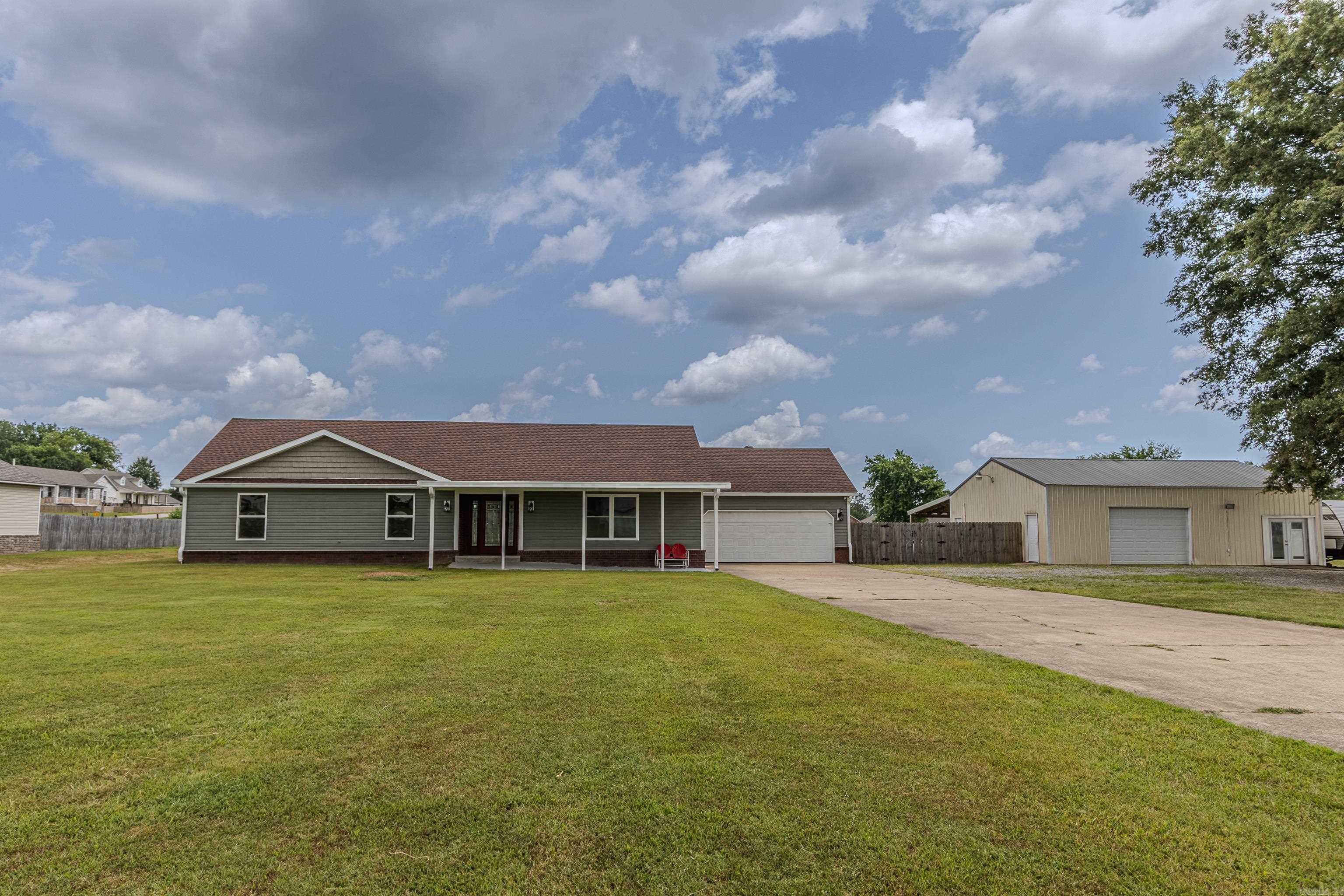 Three bedroom two bath home on 2 acres in Oak Grove with all the amenities and updates. Large spacious living area, beautiful wood ceiling, brick gas fireplace with blowers, new living room window. Spacious laundry room located off garage entrance that flows to the kitchen with Granite countertops, pebble black backsplash and stainless appliances. Dining area adjacent to kitchen large enough for family gatherings with new window and patio door. All bedrooms have new ceramic tile flooring. Custom primary bathroom with large walk in shower. 30x40 shop with a 20x40 covered addition. Insulated storage room in shop with heat/cool window unit. There is a separate entrance to half bath in shop. Wood privacy and chain linked fence approx 3 years old, along with a 30x10 covered front porch addition. and new back door to garage. Other amenities include generator, storm shelter, swimming pool and koi pond. New roof and water heater 2025.