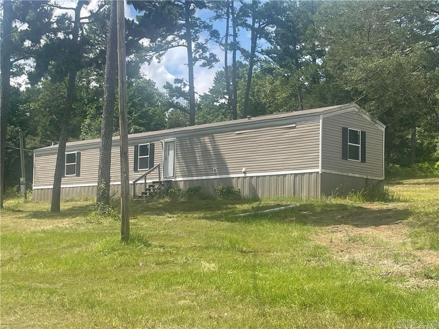MOVE IN READY! This is a new manufactured home--only a few years old. Absolutely gorgeous and in meticulous condition. 3 bedroom 2 bath with a split floor plan. Very well designed. Cute kitchen with plenty of cabinet space. Quiet, "end of the road" location with woods surrounding 3 sides. Semi-secluded and tranquil! Even offers a circle drive!