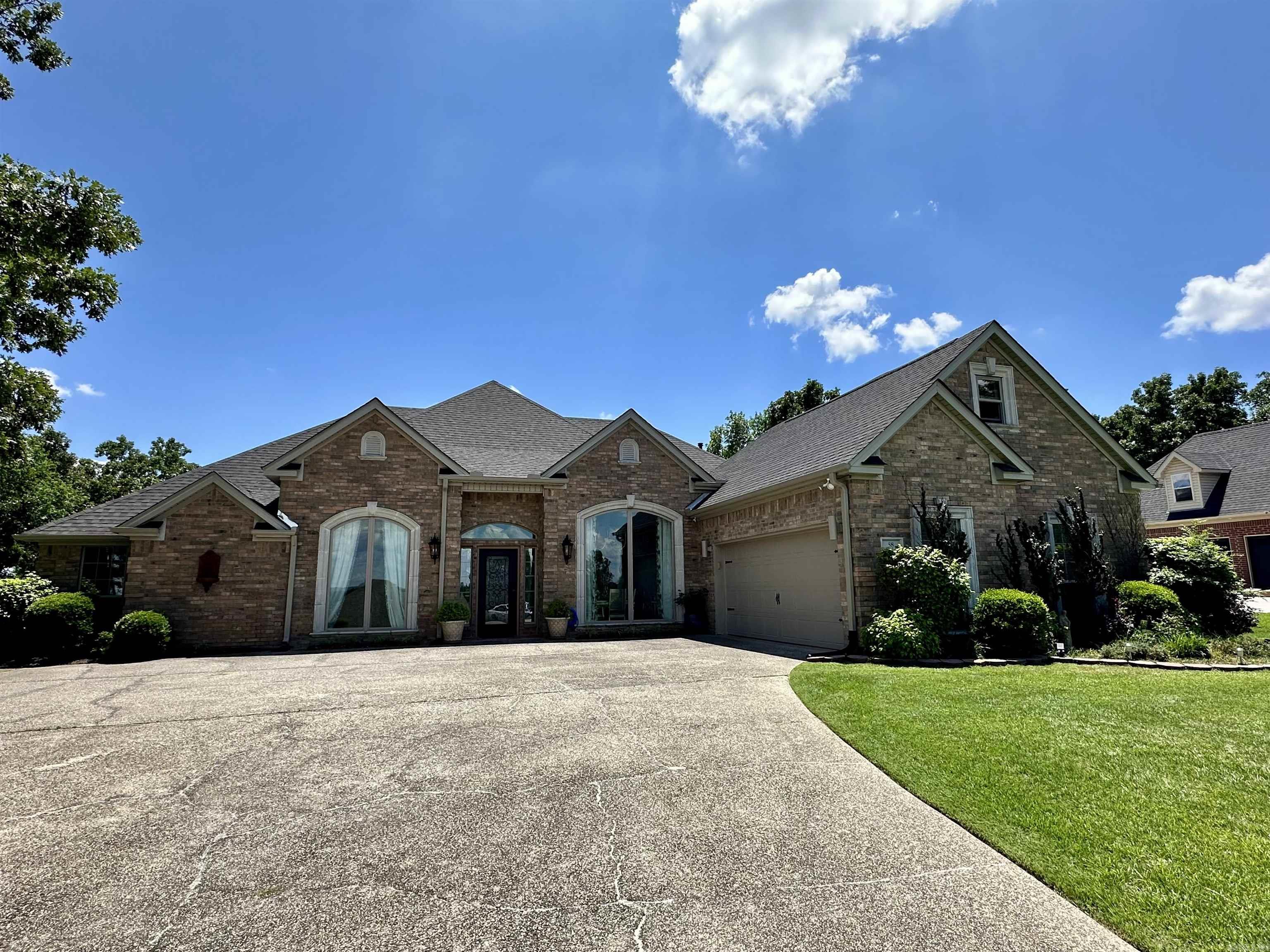 Embrace the comfort of this beautiful gated Stonegate Subdivision home. This home has been completely updated to include: engineered wood flooring, light fixtures throughout, granite countertops in kitchen and downstairs bathrooms, sinks, toilets, roof, gutters, garage door and 2 new HVAC units. Open concept kitchen overlooking the living room and breakfast nook. Large living room with a wall of windows overlooking Mt Riante with views of Lake Hamilton from the front. Elegant formal dining room and media room or office space. In-law quarters or detached office space off back deck. Tons of storage. The large back deck extends almost entire width of home. Additional lot included outside of gated backyard to east of fence to build the perfect outdoor oasis. Stonegate Subdivision offers a private boat launch and storage, pool, clubhouse and tennis courts.