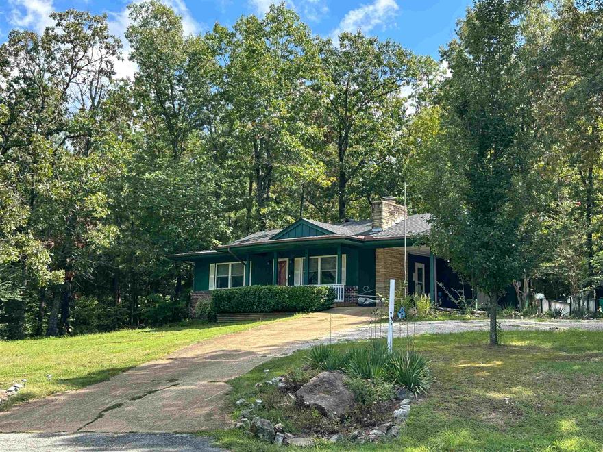 This cozy 2 bedroom, 1 ½ bathroom cottage is situated on 2 private wooded lots with winding stone pathways and a firepit.   The kitchen features beautiful stainless steel appliances with gas range, granite countertops, and open upper cabinets perfect for decorating, as well as a good sized pantry for storage. Original, hardwood flooring throughout, as well as a wood burning fireplace, and a 13x14 bonus room with decorative wood stove, add character throughout this house full of both modern updates and rustic charm.  Storage building/barn with lean to has been partially finished to be the perfect bonus space, craft room, Man Cave, She Shed, etc.  This past year the roof was replaced with 30 year architectural shingles as well as a new water heater.  Many energy saving features as well from extra insulation to a new WiFi enabled energy saving thermostat. All the important updates have been finished for you, so this great property is move in ready and ready for you!