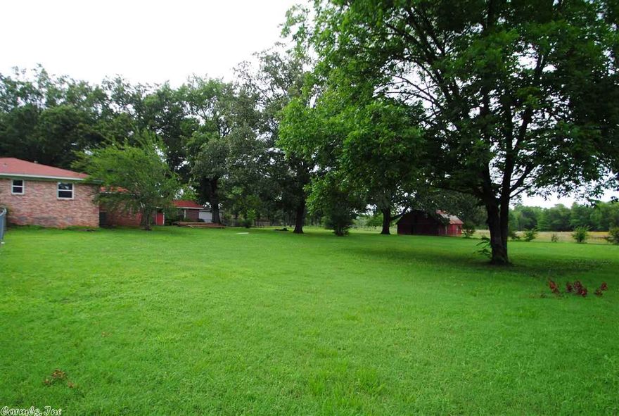 Home wit 1/2 acres within 3 miles from major shopping area, will never find another home like this. New kitchen with granite counter tops new stainless steel appliances. Fireplace. New flooring throughout the house hardwoods in the living area with huge open space. Two baths updated. Screened in back porch.  plus a separate garage. This home is completely redone from roof to foundation.  option to purchase 5.5 additional acres. A must see! St ft. is approx. please measure