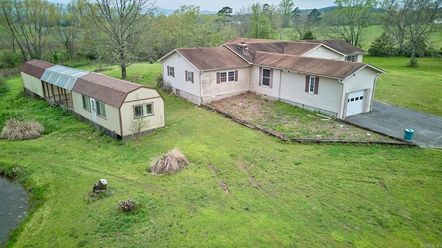 Are you looking for mountain views, a pond, and room to stretch? Comfortable Mount Ida is home to this 3 bedroom 2 bathroom ranch style property on 2.3 acres. You won't believe the storage with two out buildings that are wired for electricity - they could be great work shops or craft rooms. Inside, you'll find a large kitchen with an island along with a large primary bedroom, and a stone fireplace.