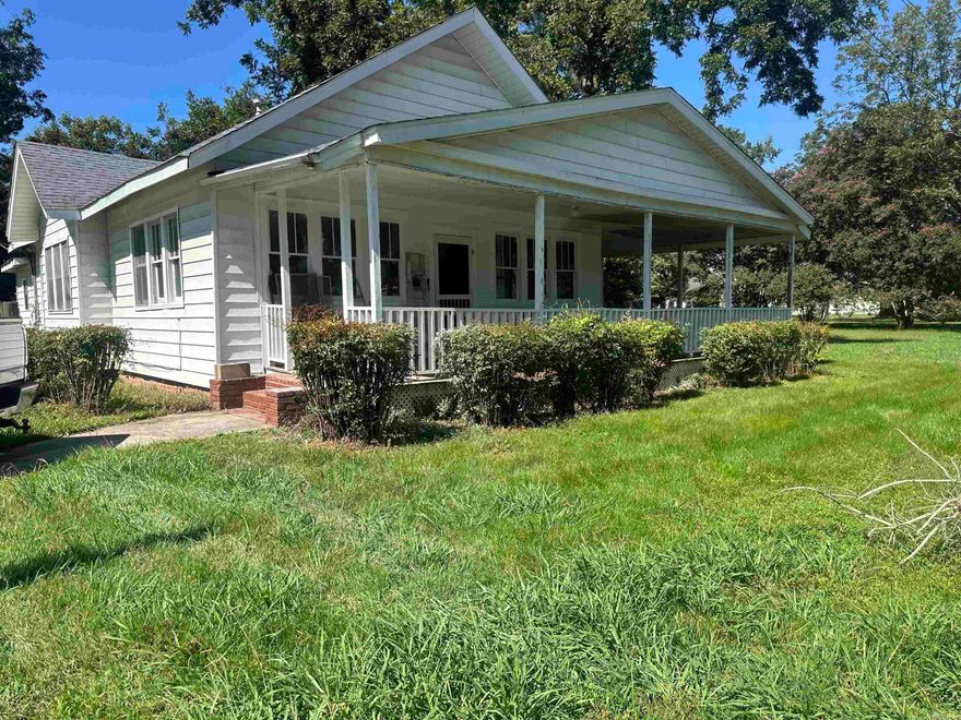 Craftsman-style charm with a wrap-around porch in the heart of Lonoke! Fresh interior paint gives this single-level home a bright, move-in ready feel. The exterior blends low-maintenance siding with brick accents and a classic wrap-around porch, perfect for morning coffee or evening relaxing. Inside, the living room features a decorative, non-working fireplace, while the dining room showcases a second decorative fireplace—both adding warmth and personality. The kitchen offers generous cabinet space and flows seamlessly into the dining area, ideal for gatherings. The primary bedroom includes a bonus room that can serve as an office, craft room, or nursery, giving you flexible space to fit your lifestyle. Bedrooms are comfortably sized, and the bathroom is centrally located. Out back, a fenced yard with mature trees provides space to garden, play, or simply unwind. Conveniently located near schools, shopping, and highway access.Year built is approximately 1921.