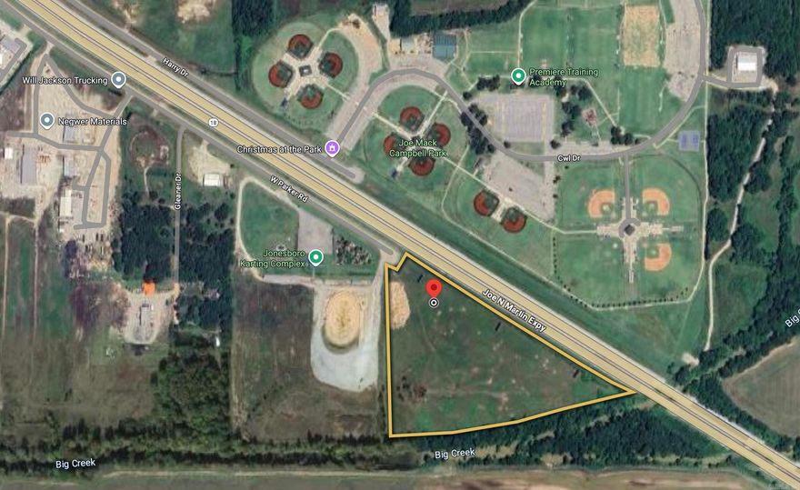 Prime development opportunity along Joe N. Martin Expressway (US-63/AR-18) in Jonesboro, AR. This 19.74-acre site is zoned C-3, making it ideal for a wide range of commercial and retail uses. Located adjacent to Joe Mack Campbell Park, the Jonesboro Karting Complex, and just minutes from major employers and residential neighborhoods, the property offers excellent visibility with an average daily traffic count of 22,000 vehicles. The site has convenient access via W. Parker Road, as well as proximity to Big Creek, providing natural drainage. Utilities, including electric & water are available nearby. With strong visibility, established zoning, and growing commercial activity in the area, this tract is well-positioned for retail, service, or mixed-use development.