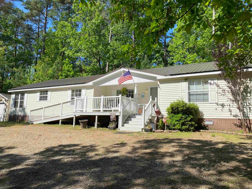 New listing in Harbor South at Mountain Harbor Resort on Lake Ouachita.   This 3 bedroom, 2 bath, approx. 1960 sq. ft. mobile home has room for all your family and friends and includes a storage building for your lake toys!  Large living room with wood burning fireplace, large eat in kitchen, crown molding, screened back porch, walk in closets in all 3 bedrooms AND you own the land the home sits on.  Improvements include new metal roof in 2024 and stainless steel appliances in 2022.  Home sits on .57 acres and is within walking distance to the Harbor South Park.  This home has been loved and it shows!  Don't miss out on this one!  Call today to schedule your private showing!