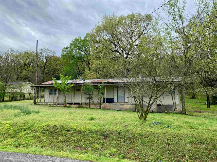 Located in Fernwood near the Arkansas River and Horsehead Public Use Boat Dock, this affordable fixer-upper mobile home is a great project for a handyman ready to put in the work. With an add-on providing multiple rooms, it offers up to 5 bedrooms or the flexibility to use one as a cozy den. New PEX plumbing is roughed in, and a new water heater and bathtub convey, but significant repairs and renovations are needed throughout. The property sits in a beautiful setting with established shade trees and offers distant mountain views from the back. If you're up for a challenge, this budget-friendly opportunity is perfect for restoring and customizing a home to your liking!
