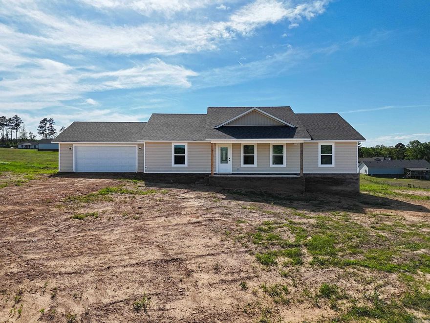 Beautiful new construction home just outside city limits offering 3 bedrooms, 2 full baths, and approximately 1,600 sq ft of thoughtfully designed living space. This home features an open-concept floor plan with a spacious living area that flows seamlessly into the kitchen and dining space—ideal for everyday living and entertaining. The kitchen includes modern cabinetry, solid surface countertops, and ample storage. The private owner’s suite offers a walk-in closet and en-suite bath, while two additional bedrooms provide flexibility for family, guests, or a home office. Enjoy the peace of a quiet setting with convenient access to nearby amenities.