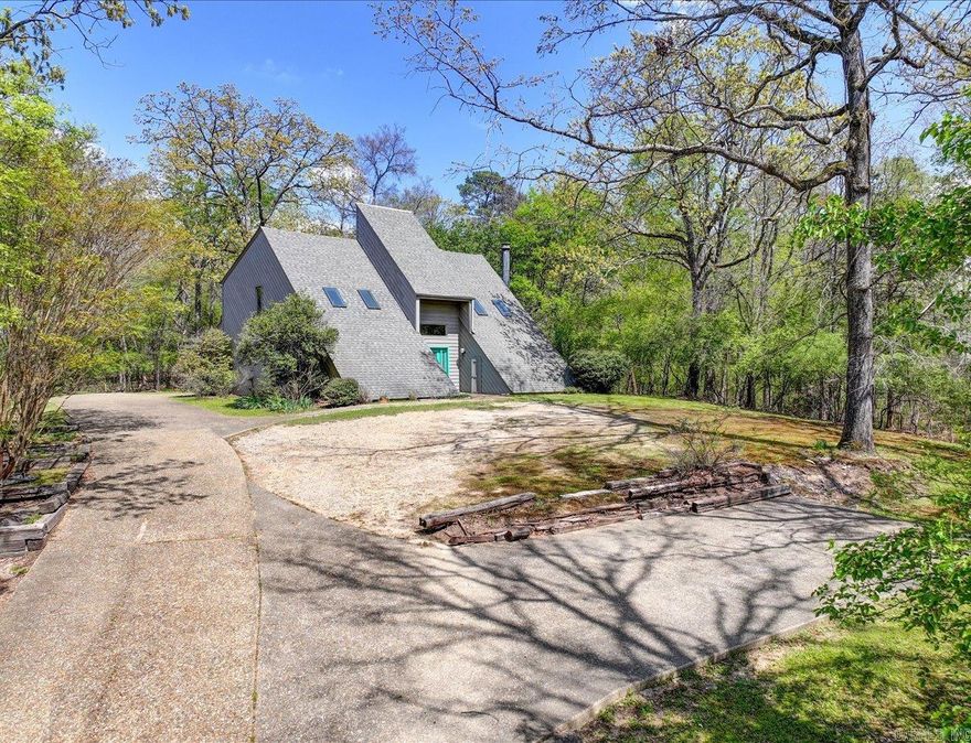 3+ Acre Lake Hamilton View Property | Peninsula Point Area  Rare opportunity to own approximately 3+ acres in the desirable Peninsula Point area overlooking Lake Hamilton. Positioned on an elevated homesite, this property offers potential for expansive, panoramic lake views and a peaceful, natural setting.  The existing one-owner home features a unique architectural design, presenting an opportunity for renovation or reimagining. Ideal for buyers looking to restore the home as a guest residence while building a new primary home to take full advantage of the elevated vista and surrounding views.  The acreage provides flexibility for potential subdivision into multiple buildable lots (subject to city approval) making this an appealing option for investors, builders, or those seeking a private estate setting.  Located just minutes from Lake Hamilton amenities, this property combines privacy, view potential, and development opportunity in one of Hot Springs’ sought-after areas.