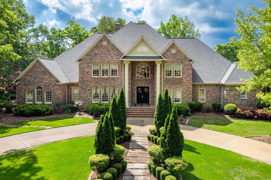 Timeless elegance and designer touches starts from the gracious formal entry leading to a formal living room and spacious formal dining room and continues to  the impressive great room with soaring ceilings, expansive windows, and a gas fireplace with built-ins. Newer wood floors flow throughout the main level. The gourmet kitchen features top-of-the-line appliances, two pantries, abundant storage, and opens to an informal dining area and cozy family room with a second gas fireplace and opening onto the deck. The luxurious primary suite includes a private office/sitting room, bedroom and a gorgeous bath with a new soaking tub. A guest bedroom and two full guest baths complete the main level. The large laundry room offers a crafting area, extra storage, and a half bath. Upstairs features a separate guest suite over the garage, two oversized guest bedrooms (one en-suite), a hall bath, second laundry, game room with bar area, and a spacious bonus room. Enjoy stunning new landscaping with a tranquil pond, waterfall, and hot tub, perfect for outdoor entertaining or quiet relaxation. Three car side load garage with storage. Too many amenities to list. Come see!