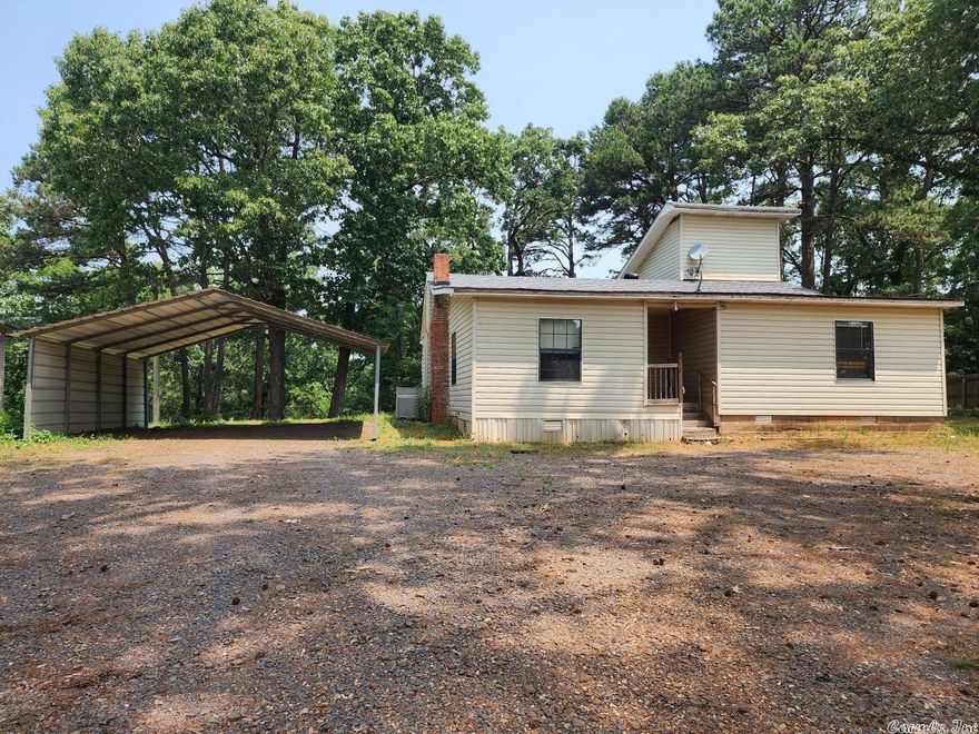 3/2 home in the country on just under an acre. All electric with $152 average electric bill. Washer, dryer, refrigerator, and large metal cabinet in the dining room convey. Kitchen has cool looking rustic cabinets, bar has build in spice rack and living room side has storage shelves. There are a 16 x 16 outbuilding with a side shed and a 2 car carport. There is old ceiling damage in a bedroom from previous roof leak. The roof was replaced in March 2023. There is a chimney that Seller has never used. It appears to be for a wood or pellet stove.