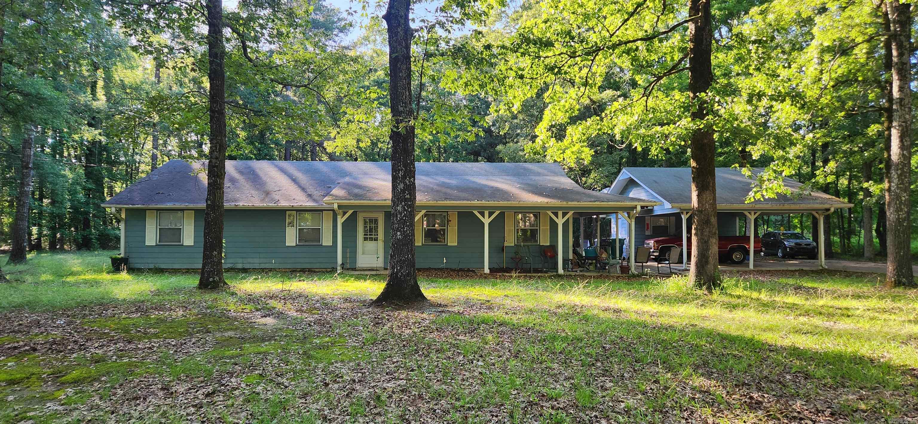 GREAT PRICE on this 3 bed, 2 bath home. New flooring, paved road, concrete driveway, 2 car carport, shop, and small shed on approx 1 acre in country but just minutes from town. Selling home "as is". Inside pictures coming soon. ****Agents see remarks*****