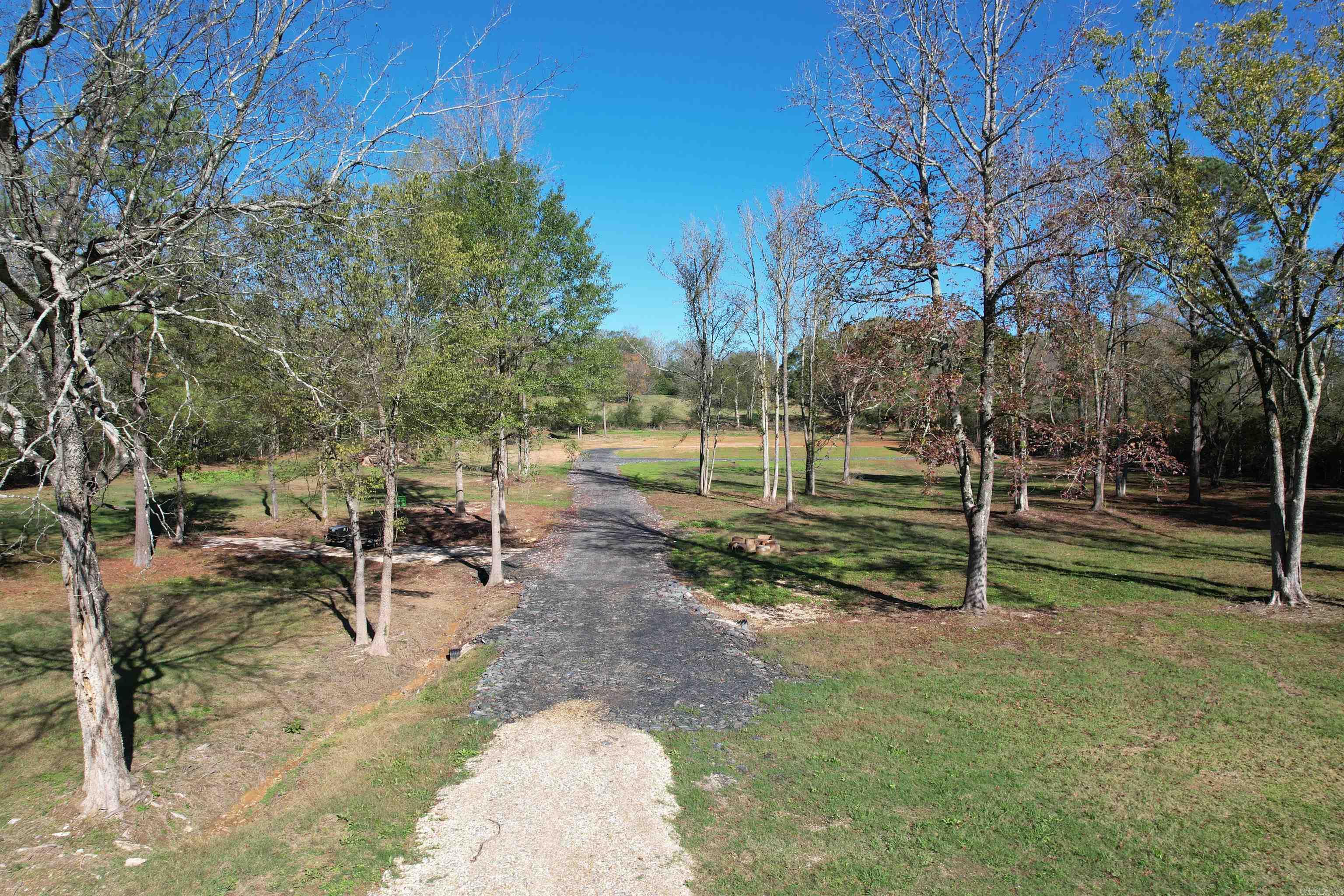 Escape the hustle and bustle of the city life with this stunning 5.51 acre vacant lot, offering a perfect blend of tranquility and convenience. Located just outside the city limits, this property boaster beautiful mature trees, giving it a serene and picturesque country feel, yet is still close to all the amenities you need-shopping, restaurants, and more, all within easy reach. With excellent street appeal, this lot offers a prime opportunity to build your dream home or explore potential for future development. It's peaceful, country like feel makes it an ideal spot for those looking to enjoy the quiet beauty of nature, while still having access to the conveniences of urban life. What's more, this property presents an exciting investment opportunity. it may be also be eligible for rezoning to commercial use, offering additional possibilities for growth and development.
