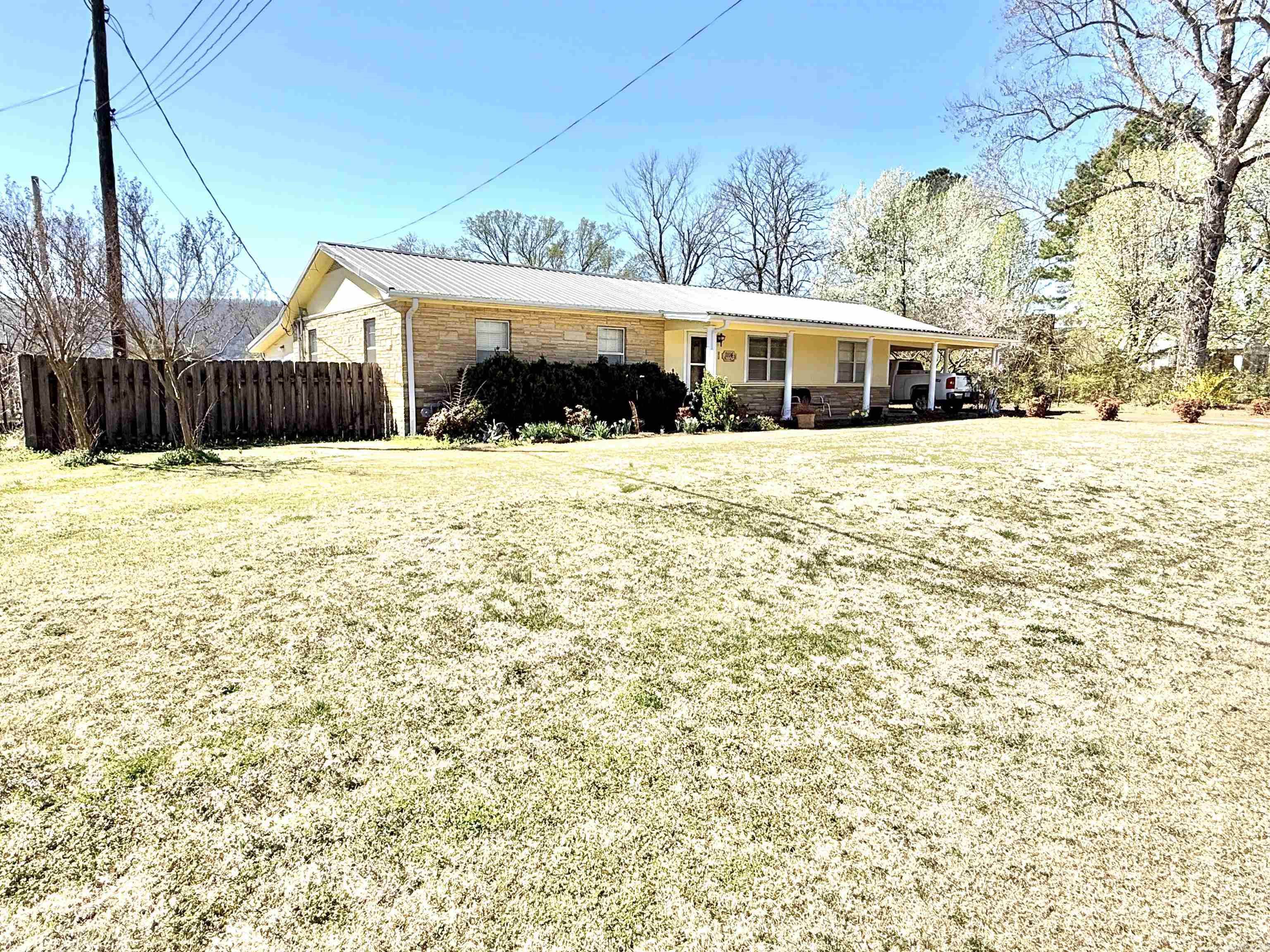 This spacious 4-bedroom, 2-bathroom home sits on a large 0.75-acre lot in the town of Mountain View, AR, with convenient access from two paved roads. Offering 2,352 sq. ft. of living space, the home features updated flooring, a bonus sunroom, a dedicated laundry room. Additionally, there is a detached 1,288 sq. ft. shop with a wood furnace, ideal for woodworking, but could easily be converted into a separate living space. Additional highlights include a metal roof, a fenced yard for added privacy, and a storm shelter for peace of mind. This property offers endless possibilities in a prime in-town location, now listed for only 319,900!