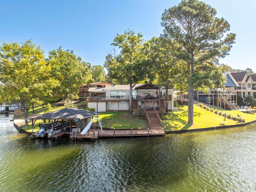 Stunning Lakefront Retreat with Fun Amenities Welcome to your dream home! This exquisite four-bedroom, four-bathroom property offers the perfect blend of luxury and comfort, all set against a breathtaking lakefront backdrop.  Step inside to discover a spacious open-concept kitchen and family room, designed for both entertaining and everyday living. The large kitchen features modern appliances, ample counter space, and a generous island, making it an ideal space for family gatherings and culinary adventures.  Outside, the beautiful outdoor entertaining area beckons you to relax while enjoying stunning views of the lake. Everyone will love the exciting slide that leads right into the water—perfect for creating summer memories! Whether you're hosting barbecues or enjoying quiet evenings by the lake, this space has it all.  With ample parking for guests and all the amenities you need for lake living, this home is truly a gem. Don’t miss your chance to experience lakeside bliss—schedule a showing today!