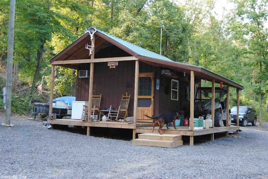 A CABIN IN THE FOREST WITH CADILLAC ACCESS, energy efficient Cabin sitting on 10 wooded acres M/L in the Ozark Mountains near Leslie AR. The Cabin has a porch on two sides, energy efficient vinyl windows. All appliances were bought new in 2011 when the cabin was built. No public water or well on the property at this time, the owner transports water in a tank from Leslie, the tank stays with property, but the trailer does not. Electricity on the property!Wonderful views with a little clearing! Nice timber!