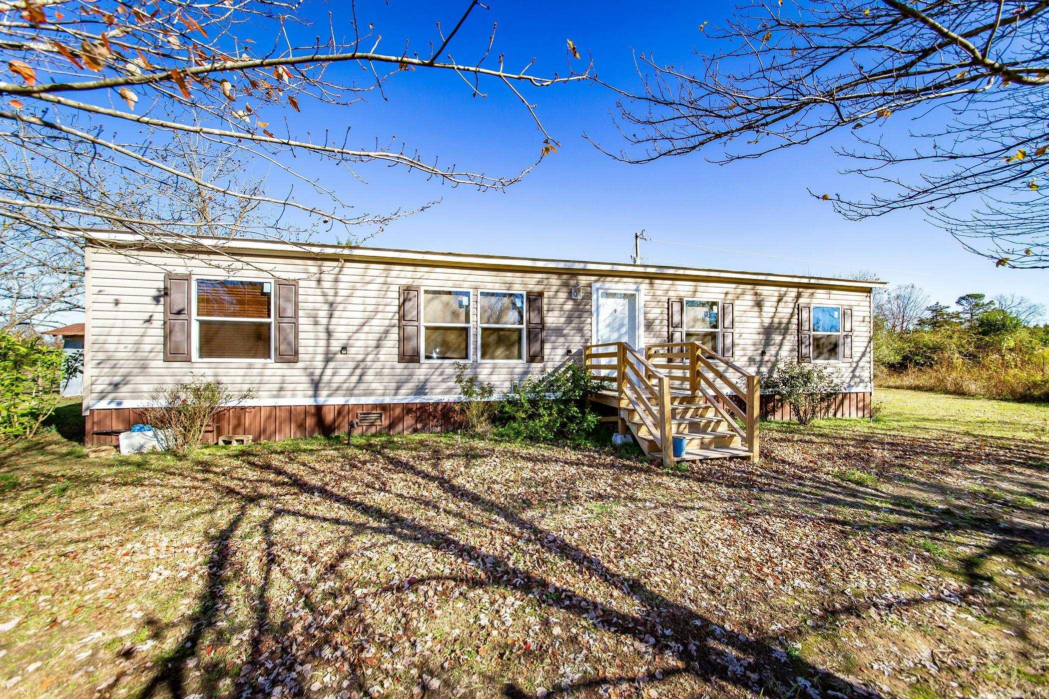 Escape to country living with this spacious 3-bed, 2-bath mobile home on 79.84 acres of prime farmland! The open floor plan features a modern kitchen with an island and a large walk-in pantry. The primary suite offers luxury with double sinks, a walk-in shower, a soaker tub, and a walk-in closet. Additional amenities include a storm shelter, a whole-home generator, and endless potential for farming or outdoor activities. Don't miss this prefect blend of comfort and opportunity! See agent remarks.