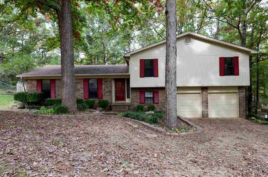 This split level home located on wooded lot of cul-de-sac is a great space buy. Complete with a formal living room/dining room combo, a den with wood burning fireplace and a great room. It also has a large deck overlooks fenced back yard.  3 bedrooms and 2 full bathrooms upstairs and a 1/2 bath/laundry room combo and craft room or office down.  A 2 car garage completes this wonderful Walnut Valley home.  This would be a great flip or add your personal style and move on in.  Very established neighborhood.