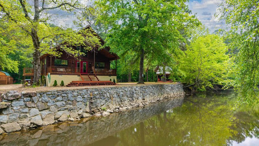 This secluded rustic retreat is in a unique class of its own. Offering the blend of a country cabin style with classic elegance. Enjoy sitting on your front porch being entertained by a wide variety of wildlife, deer, turtles, and waterfowls while the calming gently flowing sound of the Little Mazarn  takes you to your happy place! Elegant interior design boasting Asian Walnut flooring throughout, high ceilings with open views, wood burning stove and even a steam shower! Outside create your own sustainable grocery store with ample space for lush gardens and poultry. For the sports enthusiasts there's hunting, fishing, also a built-in quad/or walking trail throughout the property. Besides the Mazarn there are 2 natural springs for refreshing clean water to enjoy. You will fall in love with the Springhouse loft with outdoor kitchen with pizza oven, grill and an outdoor loft for enjoying a cozy night under the stars! Built in Generator for extra security if power goes out. You have to come check this amazing property, you will Not be dissappointed!