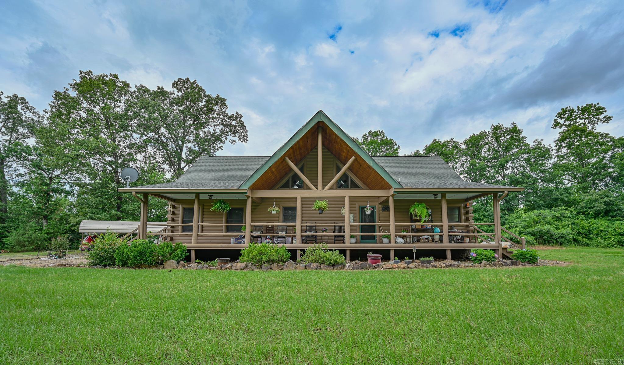 Searching for a turn-key country oasis? Take a look at this spacious, custom built, traditional LOG CABIN! Situated in the beautiful Oden area, this property includes 31 acres of both pasture and forest land. Youāll first notice an expansive, welcoming front porch just waiting to be enjoyed! Step inside and see the beautiful knotty pine interior and lodge like open concept layout! Living area Features include gorgeous wood floors, high ceilings, and a WOOD PELLET STOVE. The kitchen is outfitted with new stainless steel appliances, a JennAir range electric stove w/ down draft, lovely wood cabinetry with expertly crafted pull out shelves, and granite countertops! The large Primary suite has new vinyl flooring, a walk in closet and an in-suite bathroom including a jacuzzi tub! The home features a lofted second story with 2 additional bedrooms! There is a screened in back patio to enjoy beautiful summer evenings. This property BORDERS NATIONAL FOREST on 2 sides! A CREEK runs from the National Forest through the property, adding even more value to this special property. There is also a 30x40 ft shop on the property. If youāre looking to escape it all in style, this is the spot!