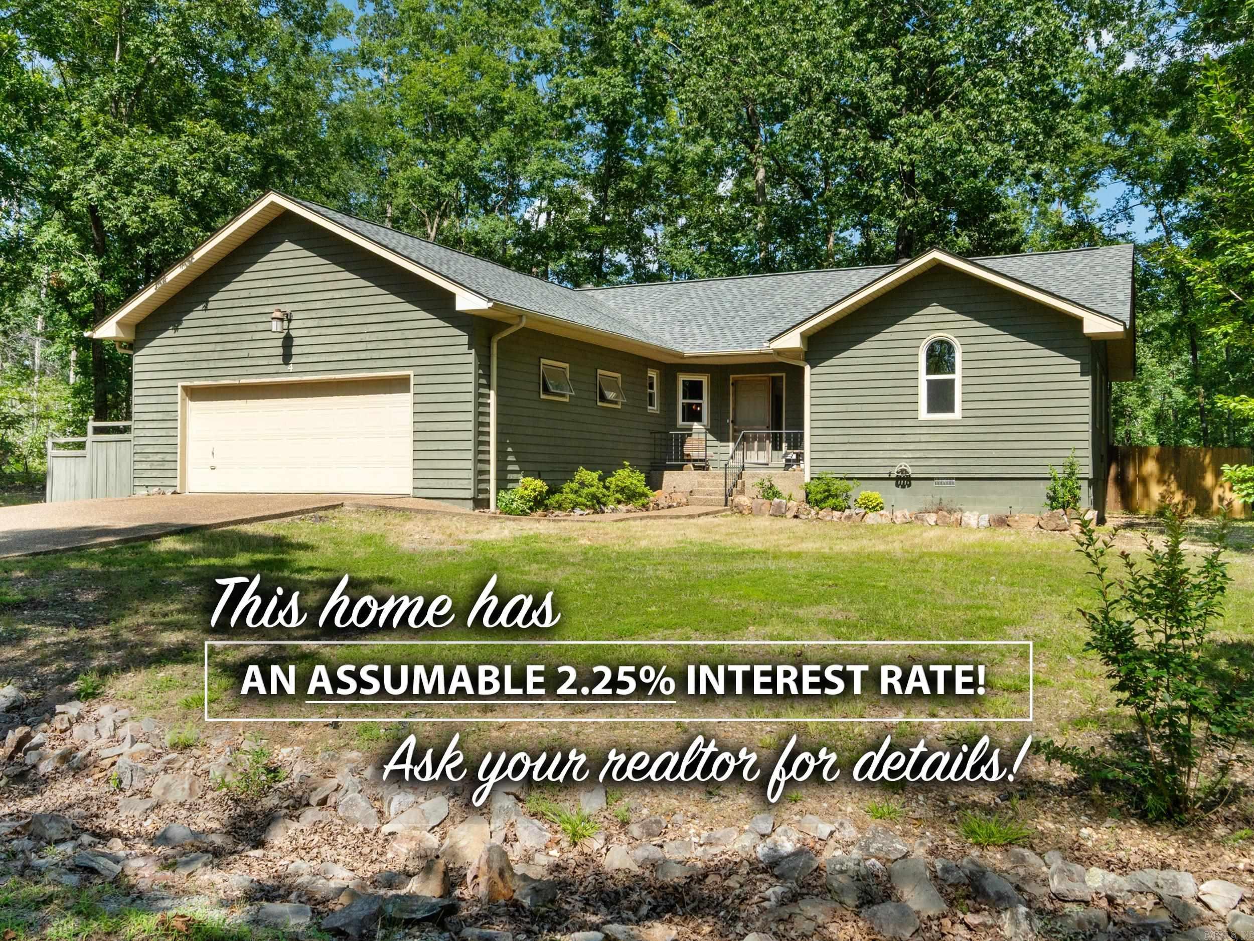 INCREDIBLE opportunity to purchase this home with a 2.25% assumable interest rate! This charming home showcases a rustic interior that perfectly embodies the Arkansan lifestyle. With 3 bedrooms, 2 bathrooms, and a generous additional room ideal for a den or extra bedroom, it offers both comfort and versatility. Step outside to a spacious back deck, all nestled in a peaceful, wooded neighborhood in beautiful Hot Springs Village, surrounded by 9 golf courses and 11 pristine lakes. Enjoy the perfect blend of privacy and natural beauty!