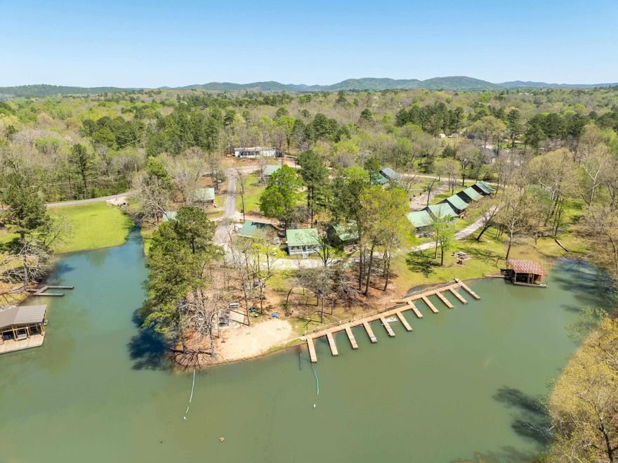 Escape to your own slice of paradise on Lake Hamilton! This two-bedroom cottage offers the perfect blend of comfort and recreation and is already established as a successful short-term rental. Whether you're looking for a weekend getaway, full-time residence, or an income-generating property, this lakeside retreat is move-in ready.  Inside, you'll find a cozy and inviting atmosphere that’s perfect for unwinding after a day of outdoor activities. Enjoy boating, fishing, or swimming in the roped-off area, and take advantage of the sandy beach common ground for picnics, shore fishing, kayaking, and more. Whether you're relaxing by the water, playing volleyball or basketball, or roasting marshmallows by the open fire, this lakeside haven offers endless opportunities for fun and relaxation.  The property also includes a private boat launch and a convenient boat ramp, making it easy to get out on the water whenever you please.   Don’t miss your chance to own this charming cottage in one of Lake Hamilton’s most desirable locations. Schedule a showing today!