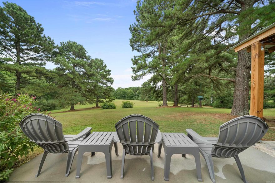 Discover serene mountain views in this beautifully renovated 3-bedroom, 2-bath retreat nestled on 3.5 private acres, completely upgraded in 2020. The thoughtful split-floor plan ensures a peaceful primary suite on one side and two guest bedrooms with a full bathroom on the other, offering both privacy and convenience. Step inside to an open-concept living area warmed by a charming fireplace, creating a cozy focal point that anchors the space. The newly updated kitchen features modern appliances, ample cabinetry, and seamless flow into the dining and living spaces—perfect for both everyday life and entertaining. Enjoy breathtaking mountain views year-round from the covered back porch or the expanded patio, ideal for morning coffee or evening gatherings. Completing this picturesque property is a detached two-car garage, providing extra storage or workshop space. This home offers peace of mind and exceptional comfort in a tranquil setting—your private oasis awaits.