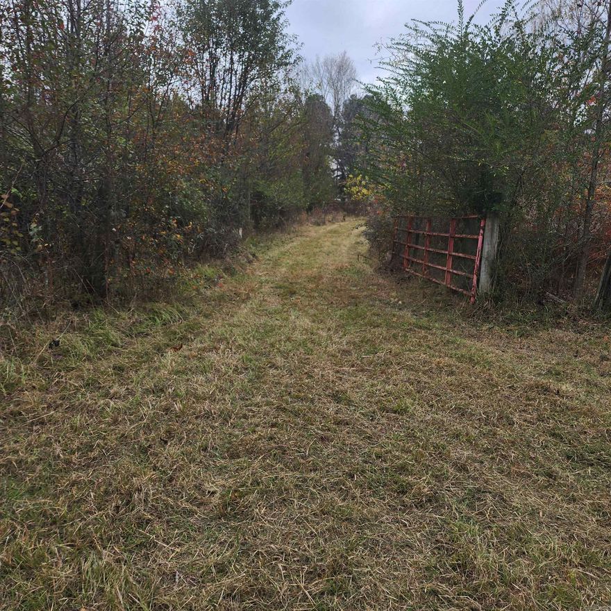 This 17.83 acres of land is just outside Searcy city limits & has a .68 lot is in Higginson city limits on a paved road. There is city sewer & water & electric at the road & a house use to sit on the lot before it burned. There are 3 additional adjoining tracts of land behind it that is not in the city that would be unrestricted. It is not in the floodplain & is fenced & cross fenced. Pastures has grown up & buyer will need some fencing repairs & debris removal but would make a great mini farm or hobby farm with room to ride ATV's or horses. Some hardwoods & deer, rabbits & squirrels visit or reside on the property. See agent remarks.