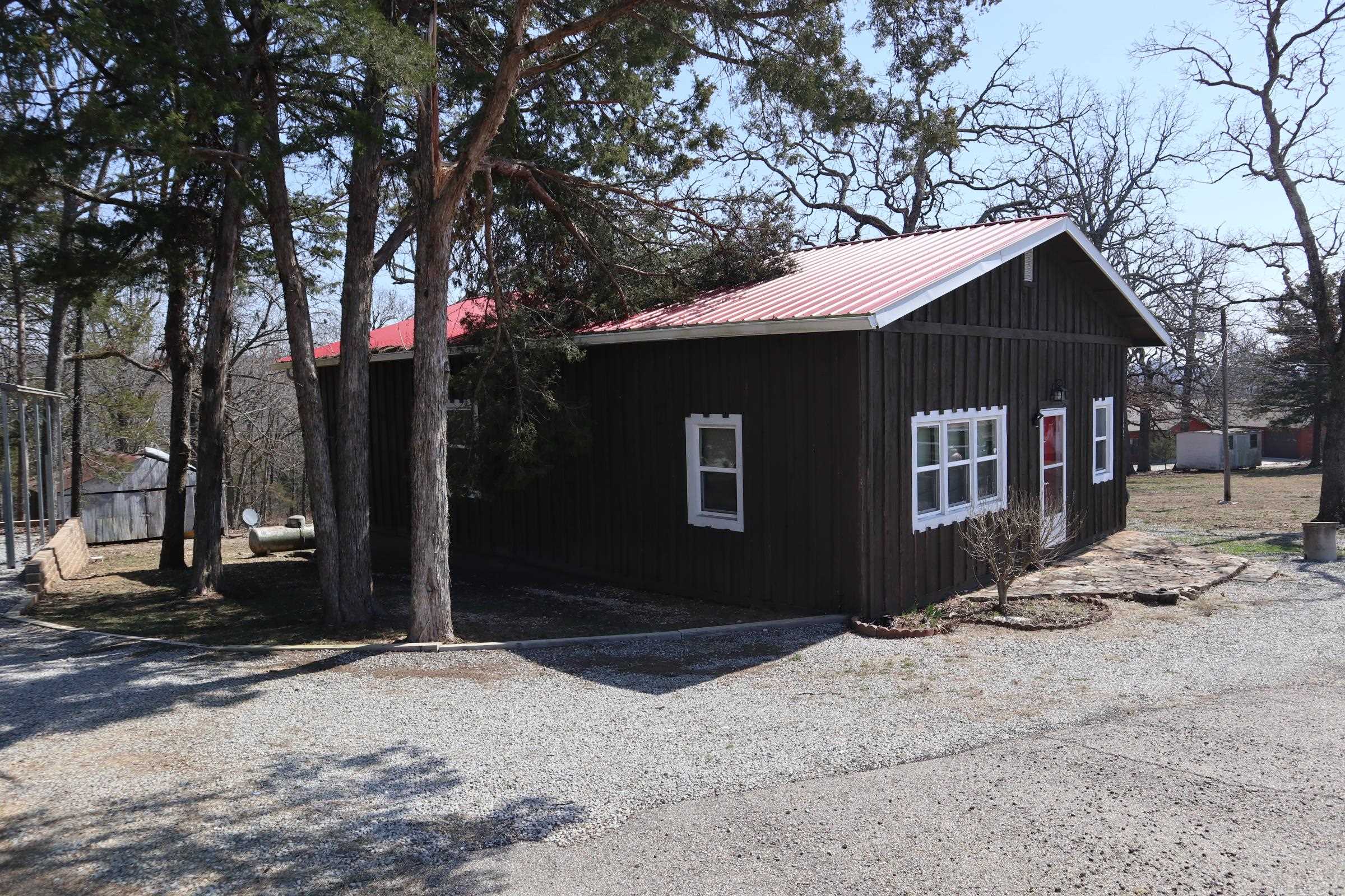 This property in Henderson, Arkansas offers a unique blend of rural charm and recreational opportunity. Featuring a well and septic system, it's primed for comfortable living. Its past use as an Airbnb highlights its potential as a weekend getaway or investment property. The location boasts proximity to Norfork Lake, visible across the highway, making it ideal for water sports and outdoor activities. Nestled in north-central Arkansas, the property is conveniently located near Mountain Home in Baxter County. This area is known for its scenic beauty and abundance of recreational options, providing a peaceful escape while remaining accessible to amenities.
