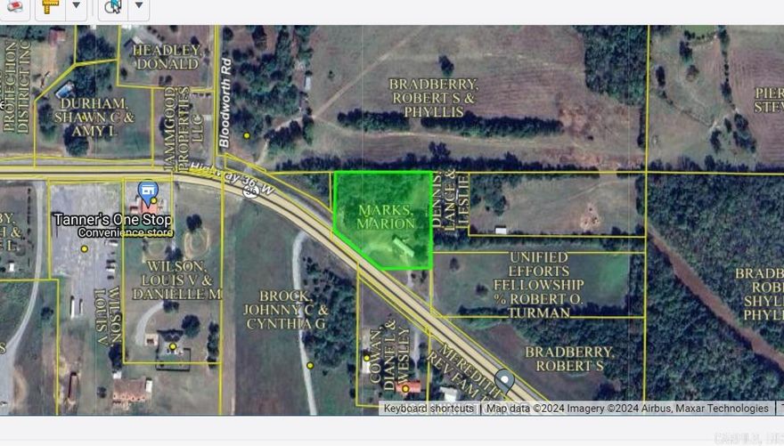 Great location to build a residence or business in the Center Hill community. Nearly 2 acres with highway frontage. Has city water, electricity, two old outbuildings, two septic tanks, mature trees. Mobile home sold "as is" and is a fixer-upper. There is a storm cellar behind the shed. See Agent remarks.