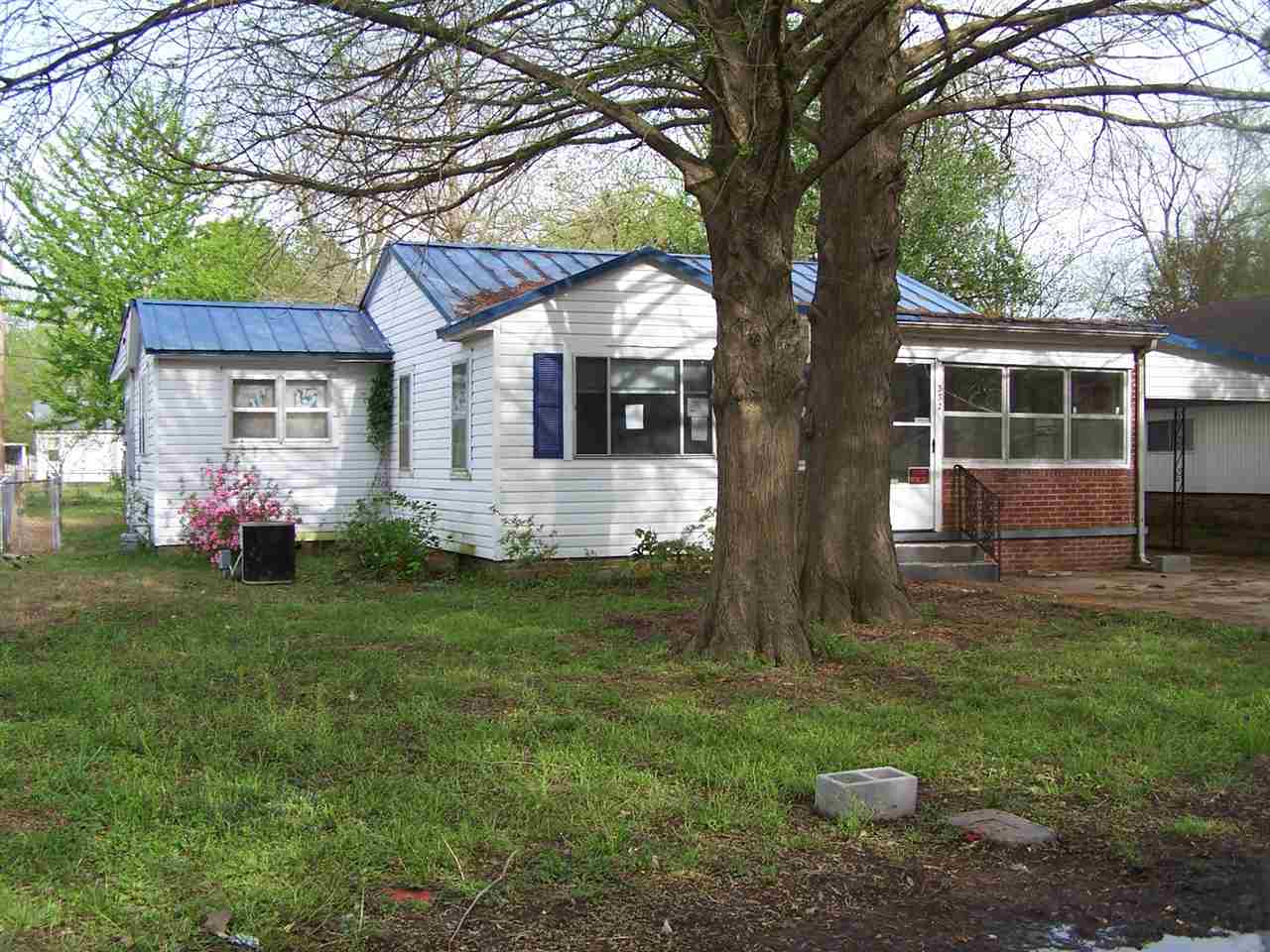 Opportunity awaits....Spacious 2 bedroom, 2 bath home with lots to offer. Conventionally located near all amenities of town. This home features a nice sized living room, spacious eat in kitchen, two true bedrooms, and three additional rooms that can double as an extra living area, office, or storage space. This home would make a great investment property or a place to make your own.