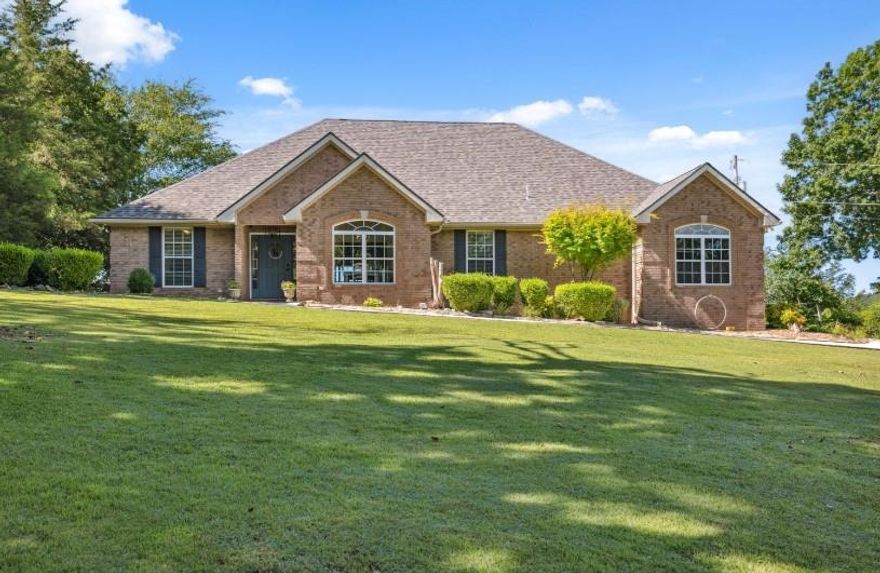 Charming Blufftop Beauty on Nearly 5 Acres! Welcome to your scenic dream home overlooking the Spring River!! This 2081sqft all brick home offers the perfect blend of comfort, style & natural beauty. Home has spacious bedrooms, 2 full baths PLUS dedicated office, perfect for remote work or can easily serve as a third bedroom. The kitchen & bathrooms have been tastefully remodeled, offering modern appeal. Master en-suite spa-like bathroom is a dream!! Kitchen includes stainless steal appliances and granite counter tops. The open floor plan is flooded with natural light, hardwood floors and a split bedroom layout for added privacy. Enjoy your mornings or evening sunsets from the large deck with vista views from every angle, while listening to the waterfalls below. Take an ATV drive right from the property to the river below or enjoy the miles of nearby off road trails! The property includes a 2-car attached garage as well as a separate 26x24 outbuilding. The outbuilding is fully insulated and has many possibilities including conversion for additional living space. A new roof was added along with an additional outbuilding in 2023. This property is a GEM and checks all the boxes!