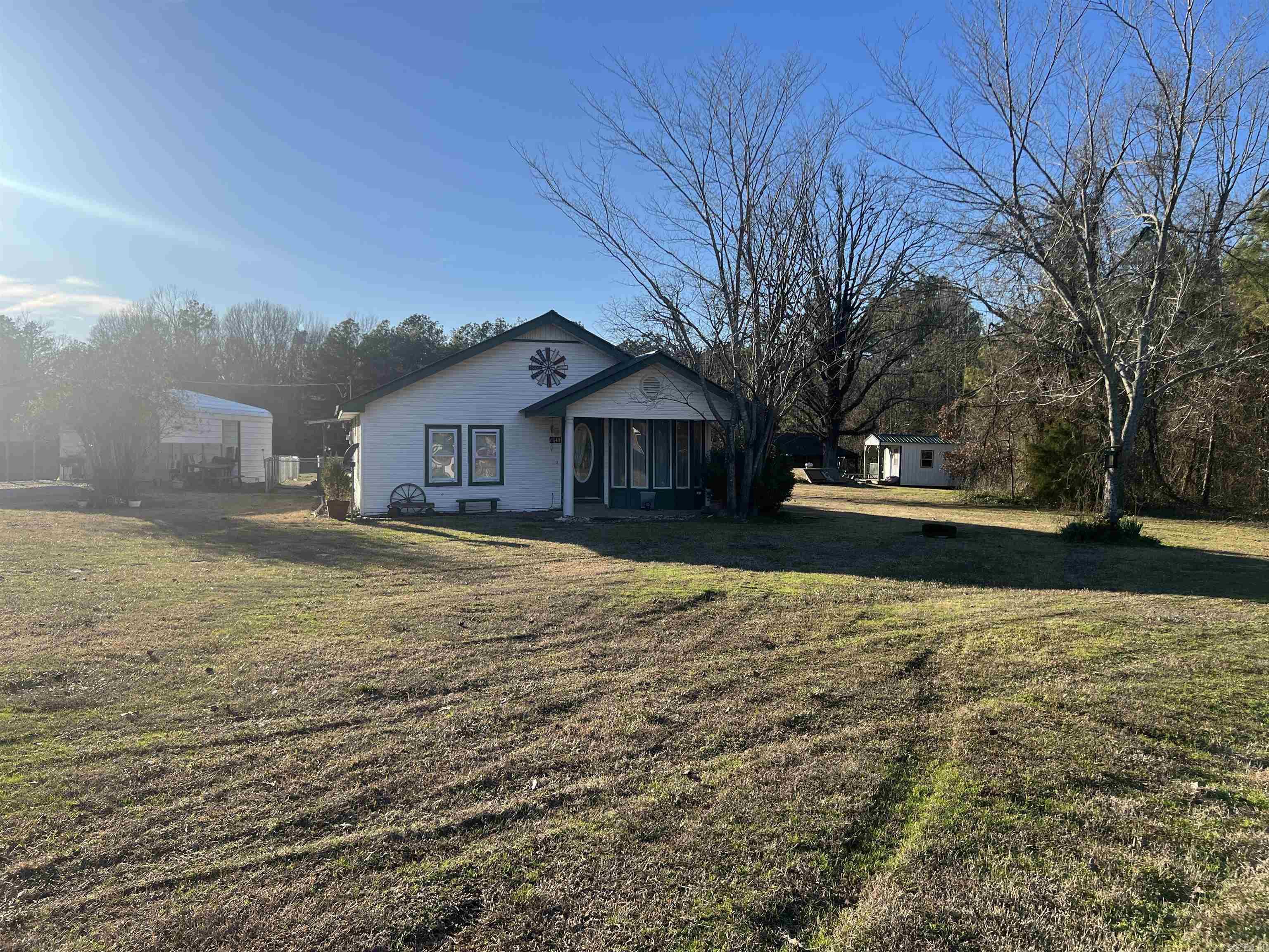 Nicely maintained 3 bed 2 bath home with newer roof, and floors. This home has recently had a master bedroom/ entry and bath re-model with a back porch and carport/shop added on and is sitting on 6.7 beautiful acres. It has a fenced in back yard and a large pond just outside the fence. The septic has recently been pumped and new field lines ran. If you're looking for country peaceful living, this one is for you. Located in a rural development eligible area.