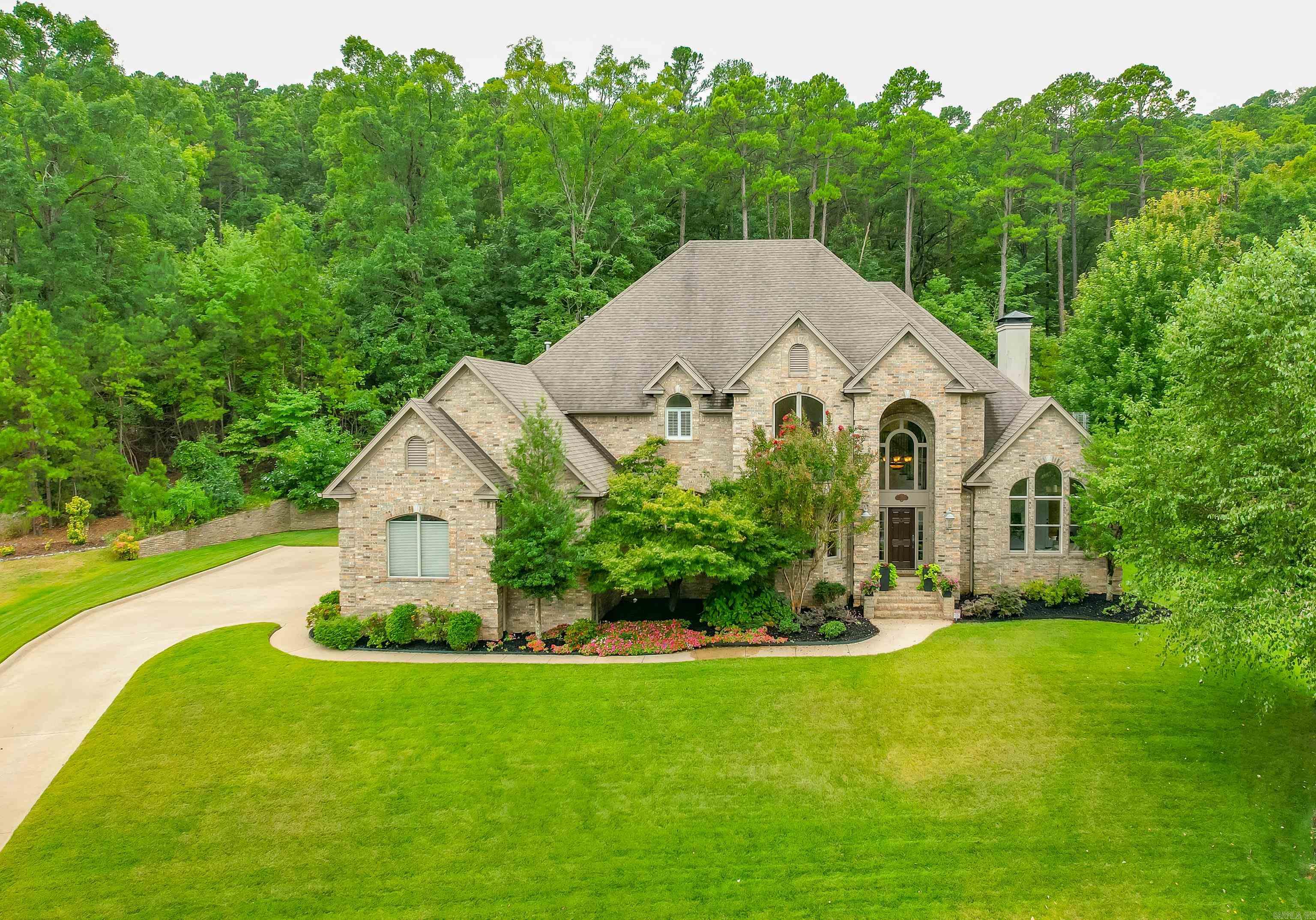 Perched upon the hill-top, enjoy the magnificent views and escape the road noises that everyone else has to hear. Whether you are inside or out, peace and quiet is what comes with this home. An exquisite custom-built home in the Maisons neighborhood. Imagine stepping into a world of elegance with 10' ceilings that elevate your living experience. The heart of this home is the spacious, open kitchen, with quartz countertops and top-of-the-line appliances. The kitchen flows into the hearth room where you can enjoy cozy evenings or step outside to the covered porch that wraps around one side of the home to enjoy the serene and private views of your backyard. The expansive primary suite has not one but two walk-in closets, a sitting area and a custom-designed bath that feels like your private spa. Upstairs you will find 3 additional bedrooms and 2 full bathrooms, offering ample space for your family or guests. The bonus room is large enough to serve as a 5th bedroom, playroom, or second home office. This home isn't just a place to live but a place to create memories.