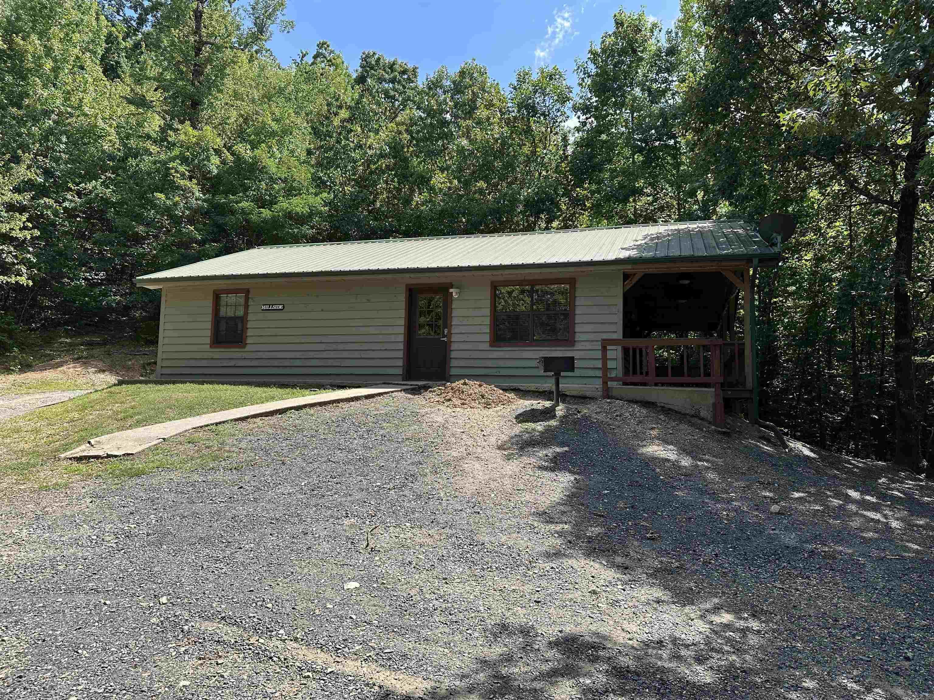 Live bordering the National Forest in the Ouachita Mountains! Nice Cabin in the woods boarding National Forest in Mena Arkansas right in the middle of Heath Valley in the Wolf pen Gap trail system! The location is amazing! There a two spacious bedrooms and two full bathrooms! The open concept living and kitchen area has vaulted ceilings and there is a nice deck with double doors leading outside! This can be your perfect vacation home or short term rental or main home! Close to creeks too! Has only ever been used as a short term rental! So much potential!