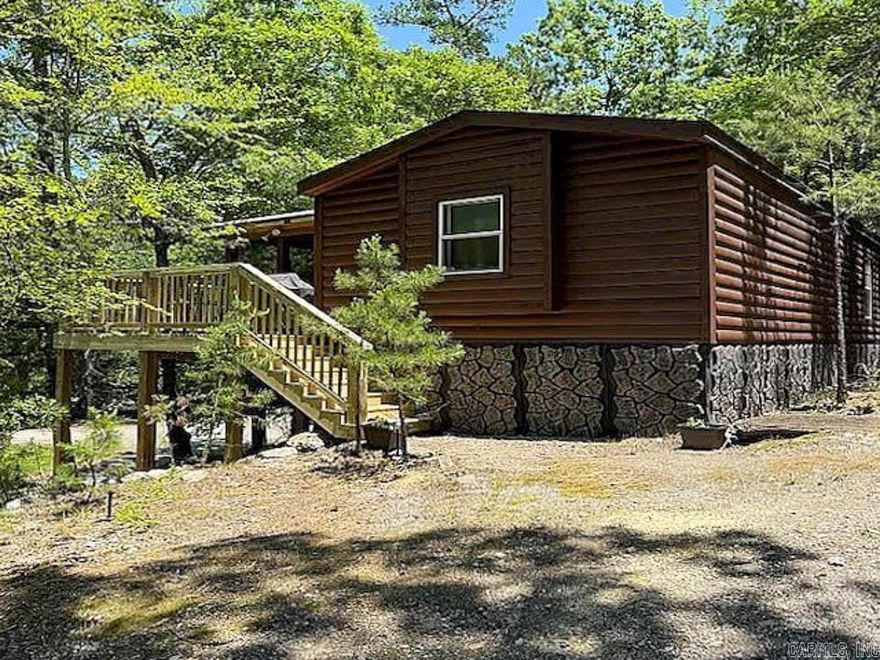 Located in the Mountain Harbor area, this beautifully maintained and fully furnished 4-bedroom, 2-bath mobile home offers comfort, space, and convenience just minutes from the pristine waters of Lake Ouachita.  The home features an expansive deck that extends the full length of the residence, complete with outdoor seating and TV area, dining space, and an activity zone with a ping pong table—perfect for entertaining or relaxing. Enjoy additional outdoor living with a designated grilling area and peaceful surroundings.  Harbor Oaks community amenities include a clubhouse, swimming pool, and safe room, providing both recreation and peace of mind. This property is ideal as a lake retreat or full-time residence in one of the area’s most sought-after lake communities.