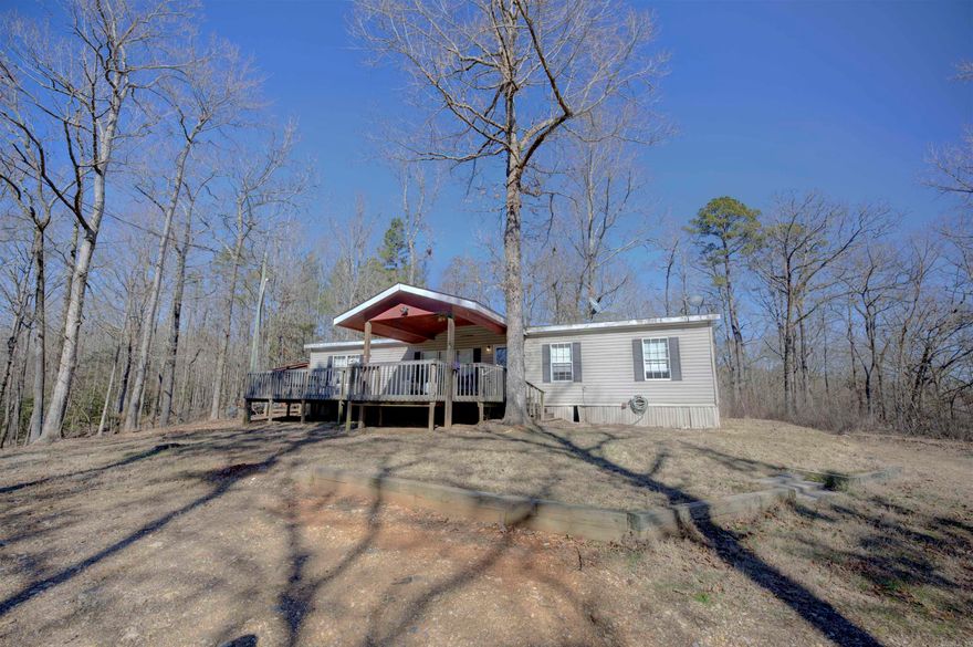 CUTE Manufactured home sitting on almost 4 acres outside of the city limits. With 4 bedrooms and 2 full baths this home has plenty of space to spread out. Wooded surroundings offer great privacy while you enjoy sitting on your front deck!