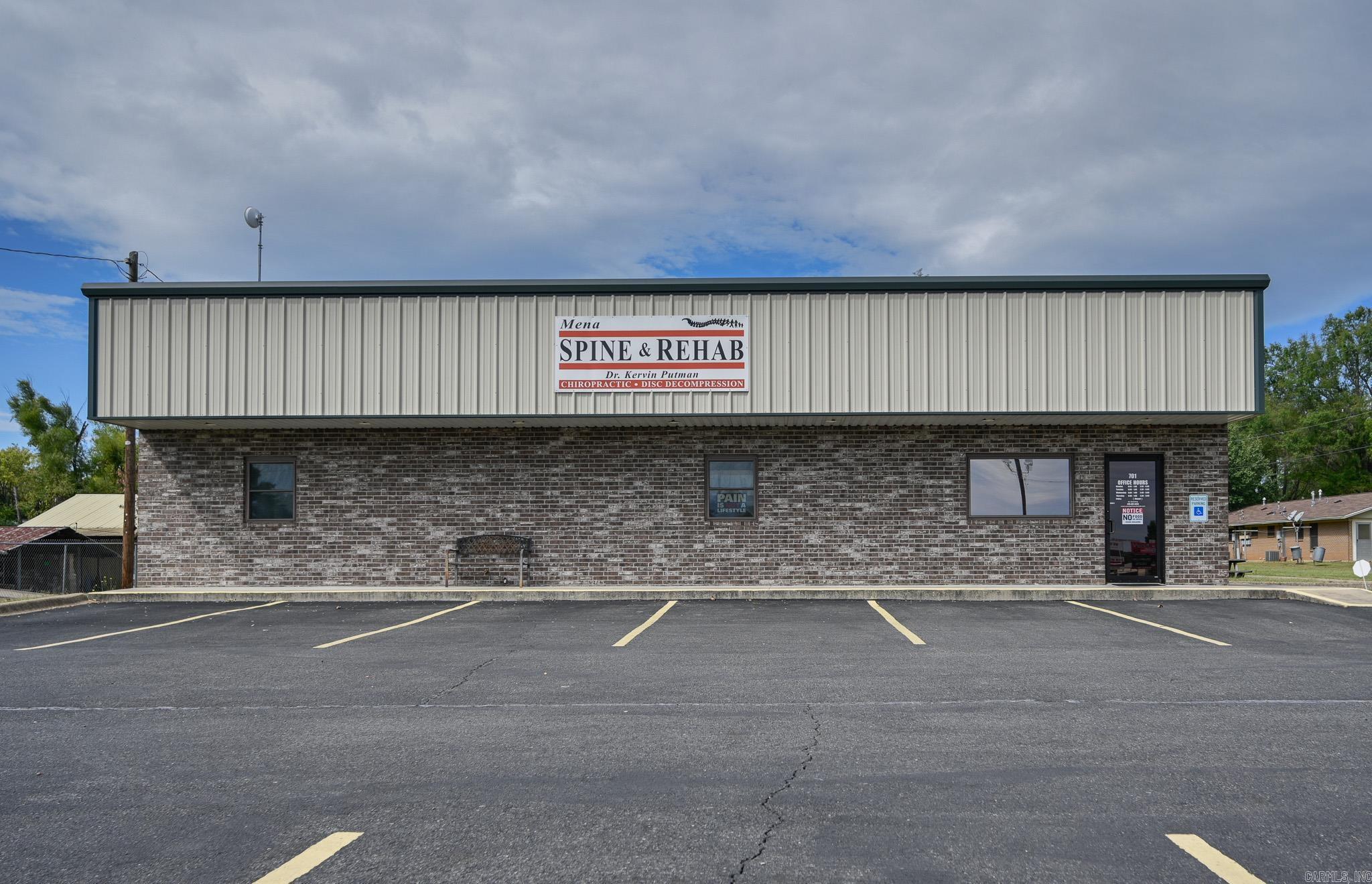 This commercial business location is in a highly visible and densely populated area of Mena, making it ideal for your new venture. The .32 acre property is complete with signage, asphalt parking lot, and landscaping. The main feature is an immaculately kept 32x60 steel building with awning and brick face. Superior soundproofing with spray foam insulation on the exterior walls and fiberglass inner insulation contributes to peace and quiet in this well-insulated space. Inside you will discover a reception area, kitchen, large open floor space, 4 rooms with sinks, an office room that includes a full bath with walk-in shower, plenty of storage, utility space with washer/dryer hook-up, and security system.