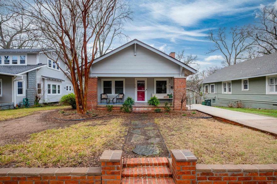 Welcome to the Hillcrest life! A spacious front porch greets you, leading to abundant natural lighting and bright open spaces as you enter this charming Craftsman bungalow. An open floorplan living and dining room with beautiful wood floors and a custom fireplace surround with built-ins are the perfect setting for relaxing or entertaining at home. The kitchen offers pantry storage, dining, large windows, and access to the deck overlooking the spacious backyard—don't miss the roll-down sunscreen making evenings outside perfect! The primary suite includes a generously sized shower and double vanity, plus second washer/dryer connections and an adjoining den with French doors that lead to an outdoor firepit area. The 8x12 cedar shed has electric and is perfect for hobbies. Gated alley access for convenience and future possibilities. Perfectly situated within an easy walk to Hillcrest amenities and close to hospitals and schools. New roof 2025, new HVAC 2022; Tankless water heater, insulated windows & doors.