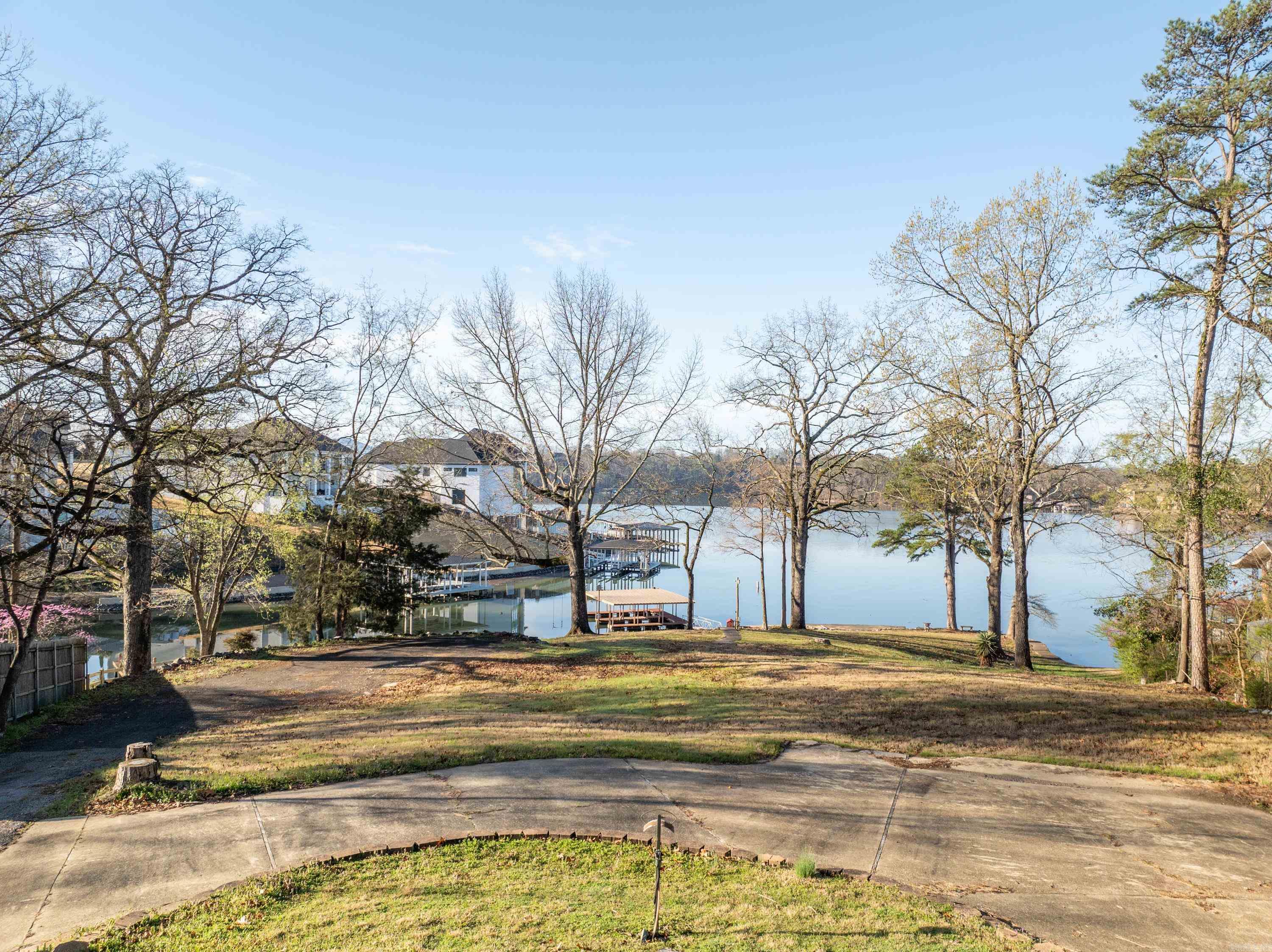 Introducing an unparalleled opportunity to own a slice of paradise on Lake Hamilton! Nestled on one of the last remaining point lots, thispremium lakefront property boasts over 225 feet of pristine shoreline, offering unrivaled panoramic views of the glistening waters.Strategically positioned in the heart of Lake Hamilton, this gem is not only a waterfront haven but also centrally located by both land andlake, ensuring convenient access to the area's finest amenities and attractions. Imagine waking up to the tranquil sounds of nature andthe breathtaking sight of the sunrise dancing across the water from your custom-built dream home. With ample space and a blankcanvas, this lot invites you to bring your vision to life and create the ultimate lakeside retreat. For developers with a keen eye, thepotential of this property is limitless. With its prime location, expansive views, and two-stall boat dock already in place, seize theopportunity to capitalize on the booming demand for luxury lakefront living. Don't miss your chance to own a piece of paradise on LakeHamilton.